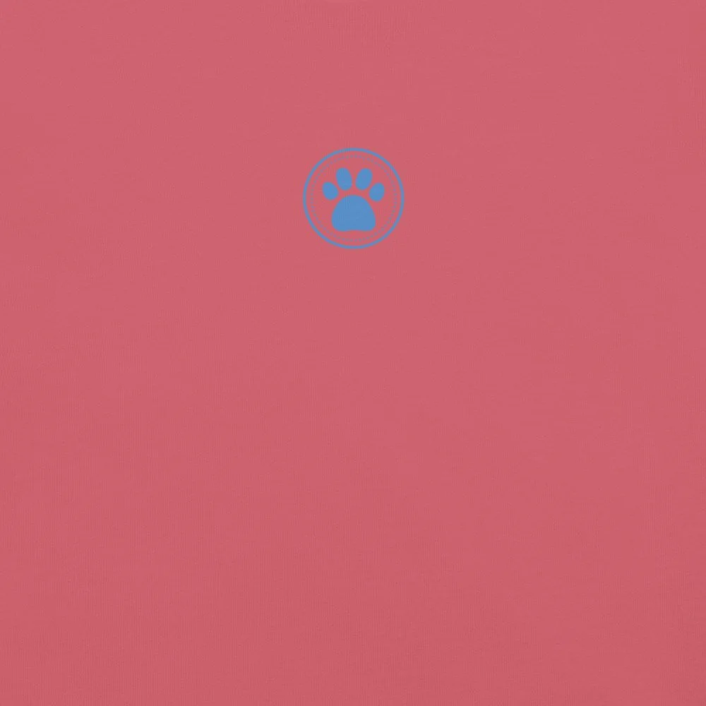 Close-up of the blue paw print on a rose-colored garment-dyed heavyweight tee