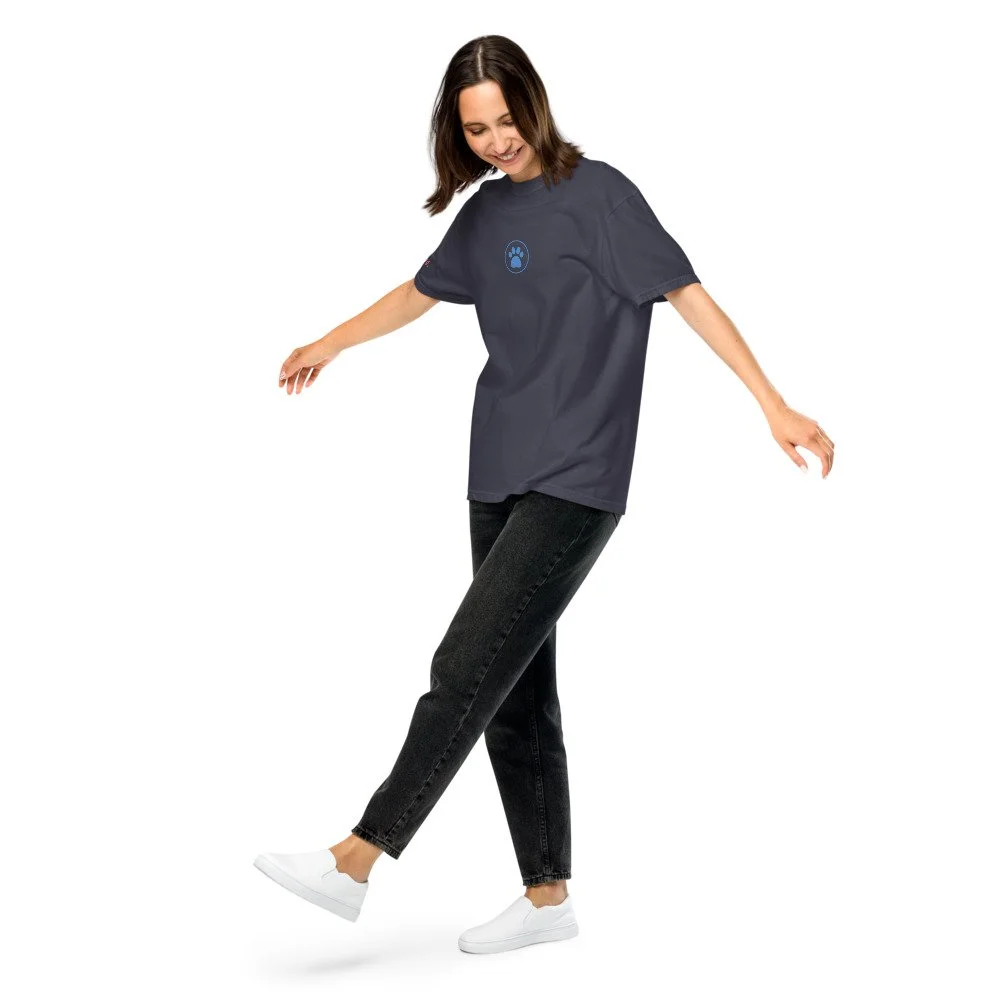 Woman wearing an navy heavyweight tee with the blue paw print on the chest