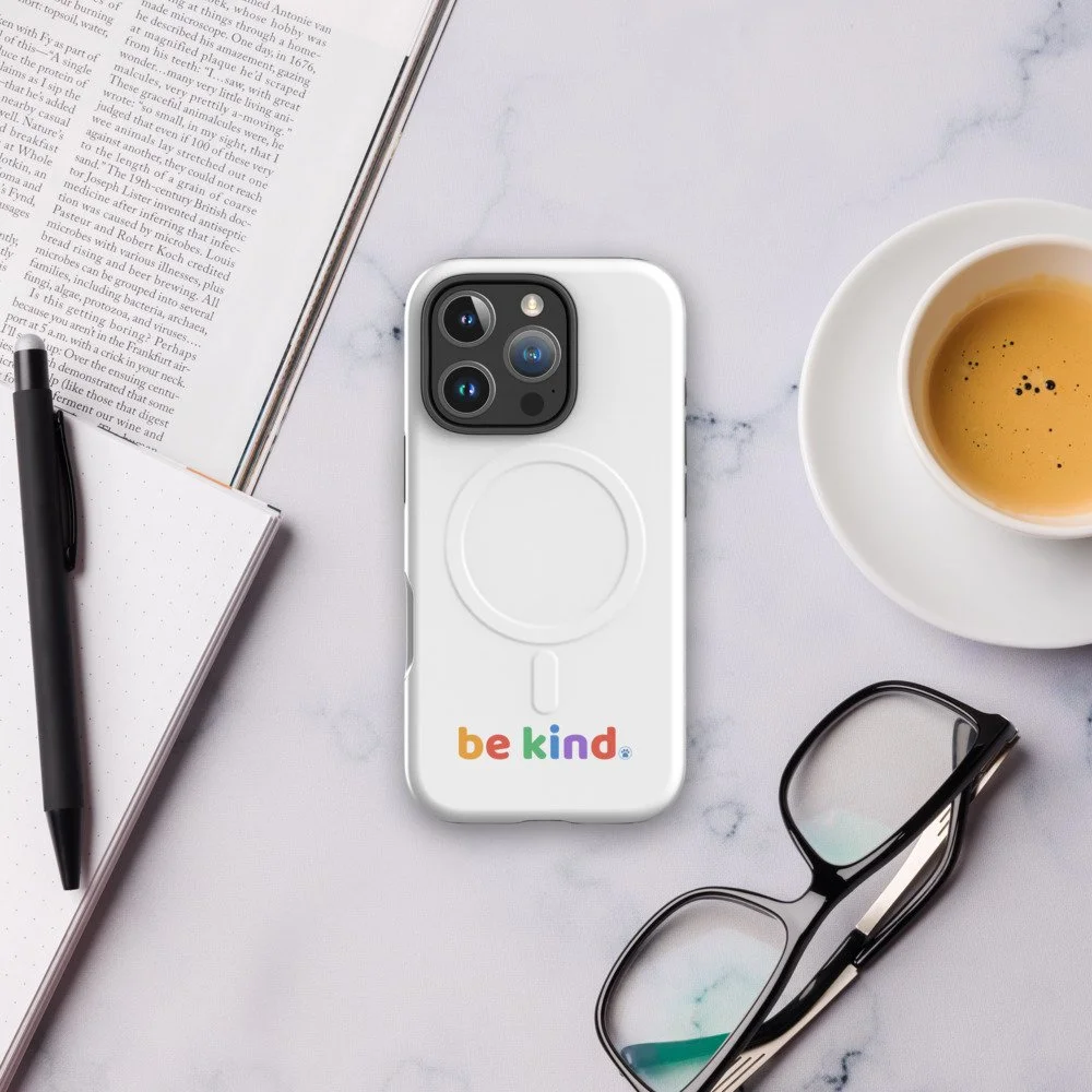 Be Kind MagSafe iPhone 16 Pro case on a marble desk with coffee and glasses