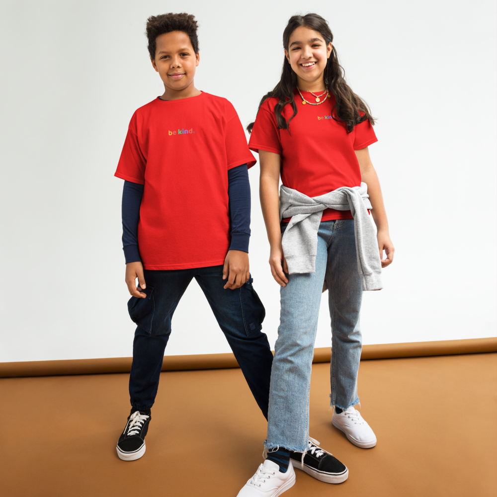 Two kids standing side by side in red be kind t-shirts