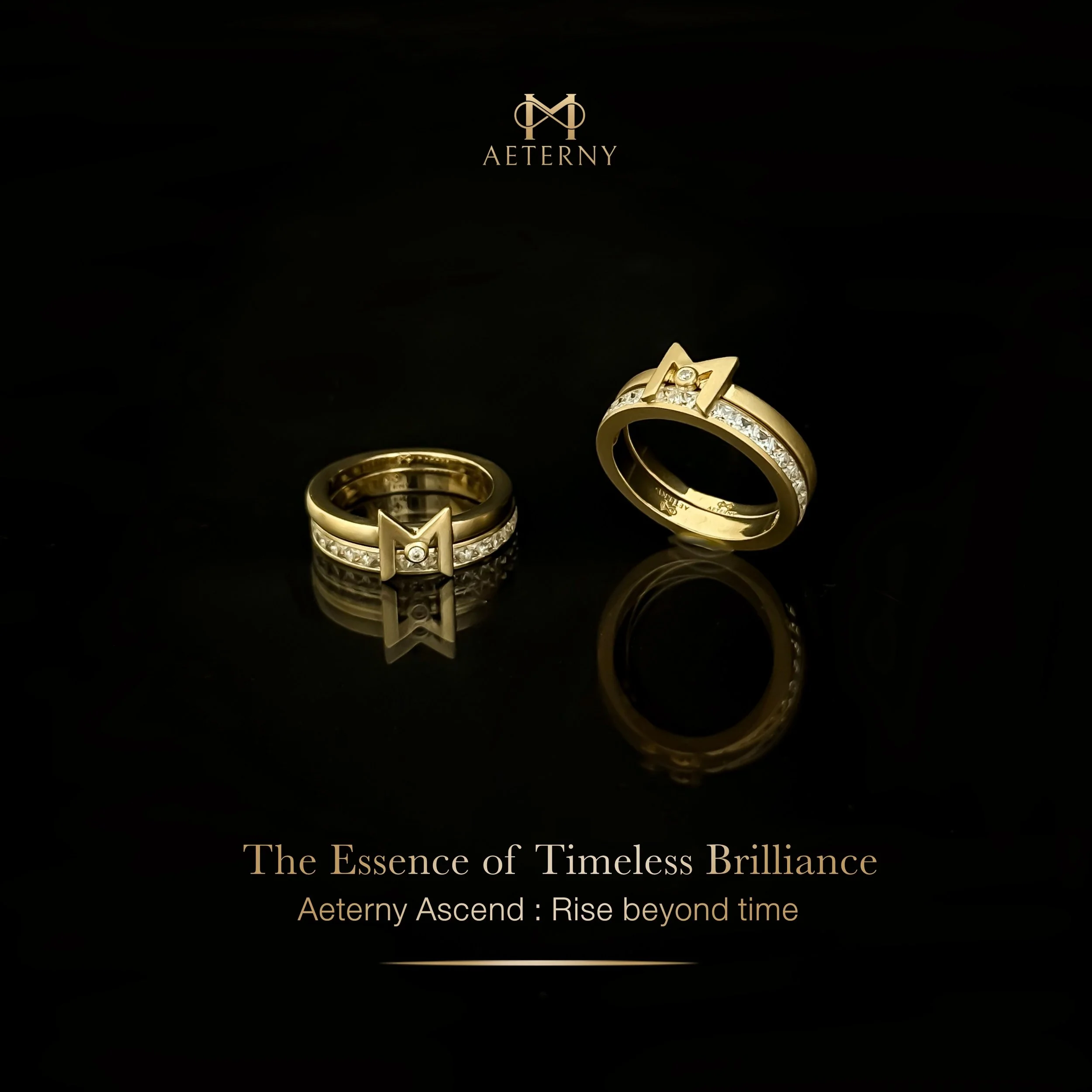 A black background with the gold logo of AETERNY at the top center, featuring an infinity symbol intertwined with a stylized 'A'. Below the logo, there are two gold rings, one with a star-shaped design and the other with embedded diamonds. The rings are reflected on the black surface. At the bottom, gold text reads: "The Essence of Timeless Brilliance - Aeterny Ascend: Rise beyond time."