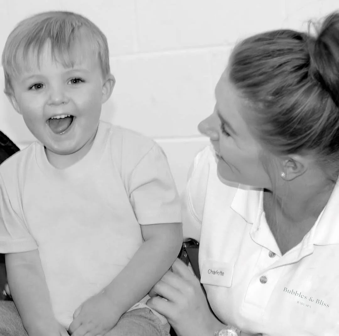 Happy staff member supporting a smiling child