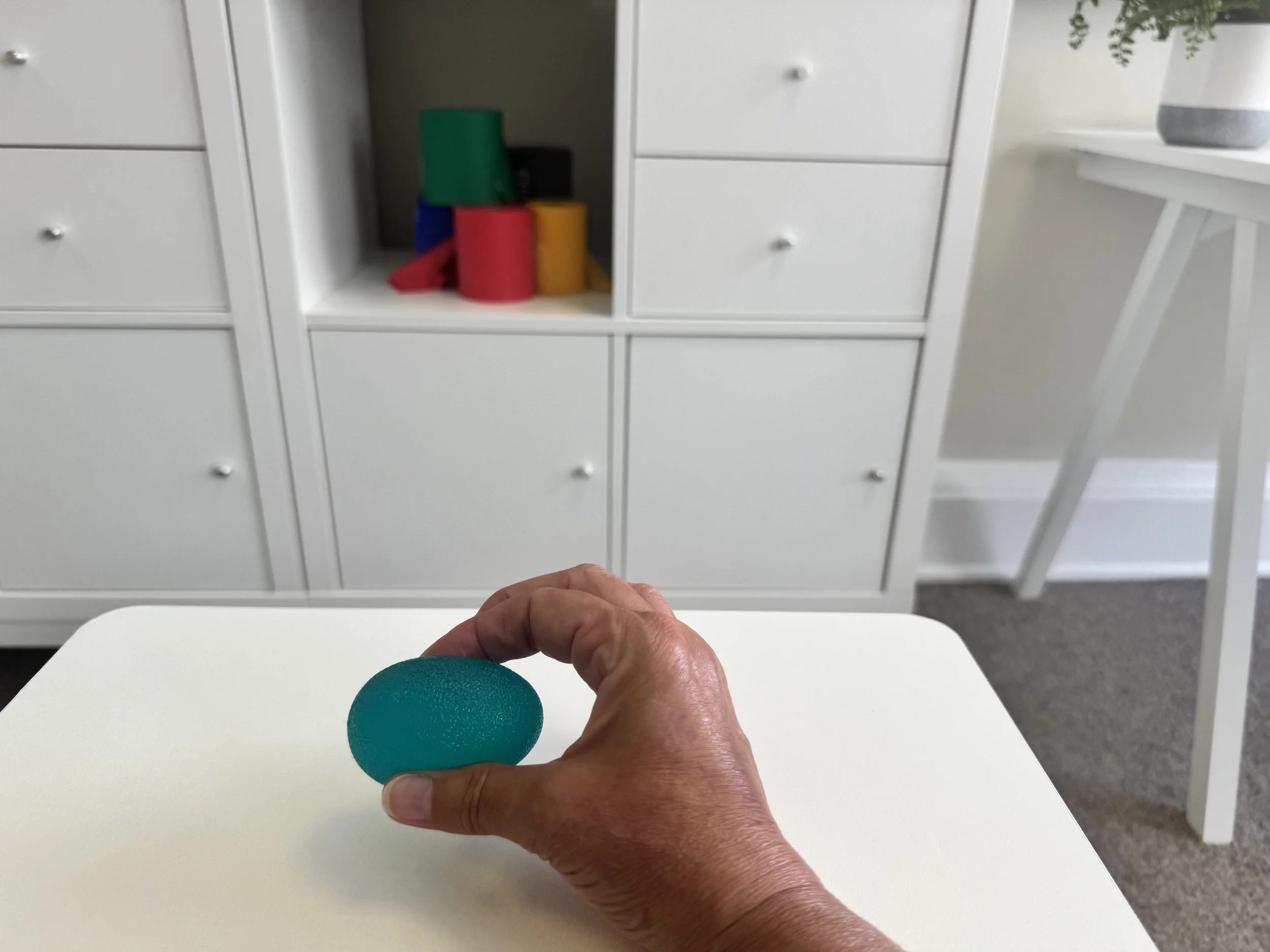 Image of therapy ball being used at Restore Physiotherapy Beverly for hand exercise.