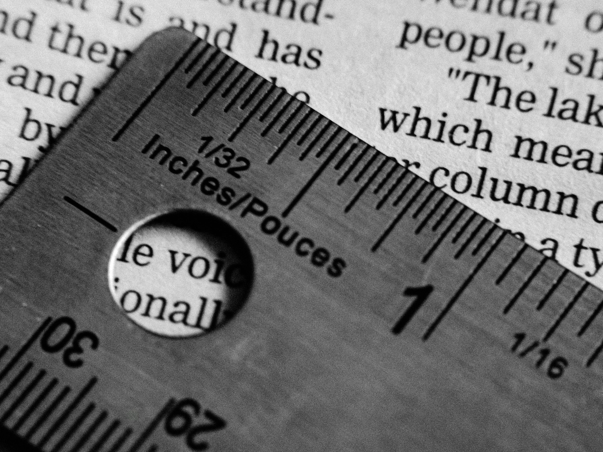 Close-up of ruler set on top of a newspaper page.