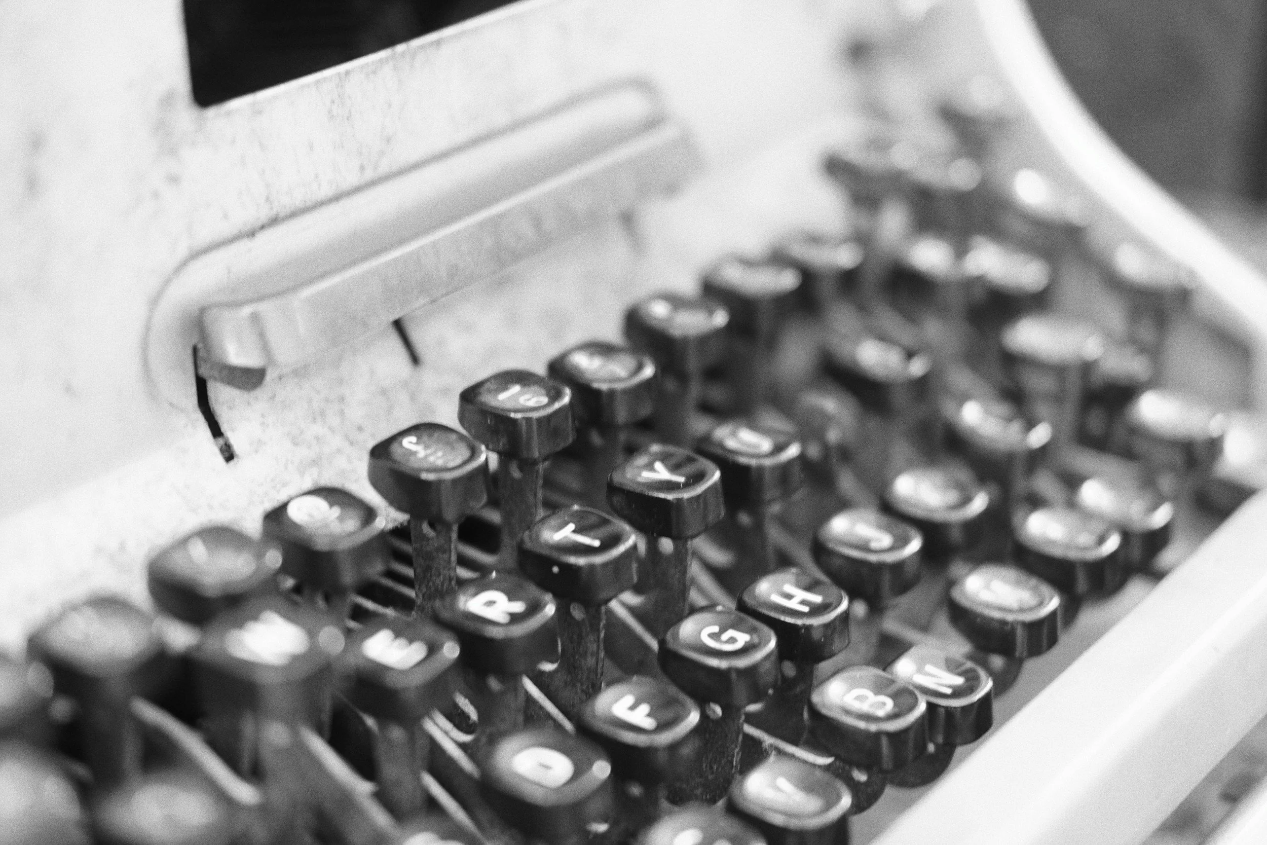 Close-up of a vintage typewriter keyboard with round keys, showing wear and tear.