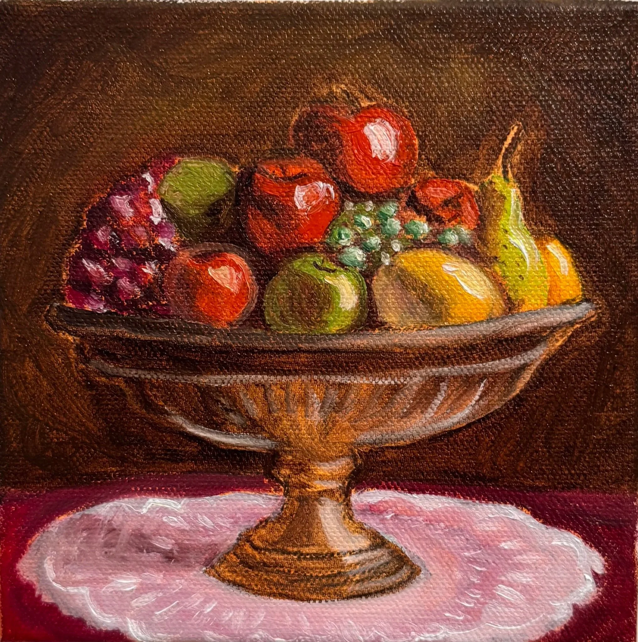 Fruit Basket, Oil on canvas, 6"x6" Close-up of a small painting featuring a still life with colorful fruits, including grapes, apples, and a pear, with a dark background and textured brushstrokes.