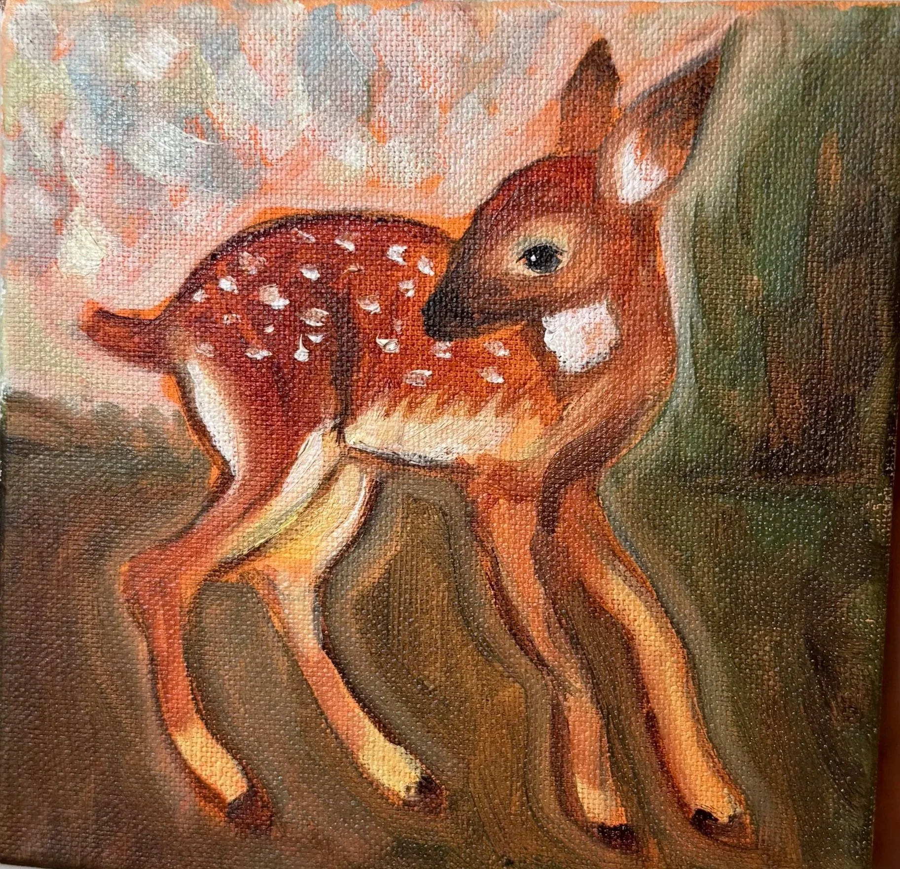 Deer in a Field, Oil Paint on canvas, 6"x6" - 2025. A small canvas painting of a young deer with white spots on its back standing on grass and trees in the background.