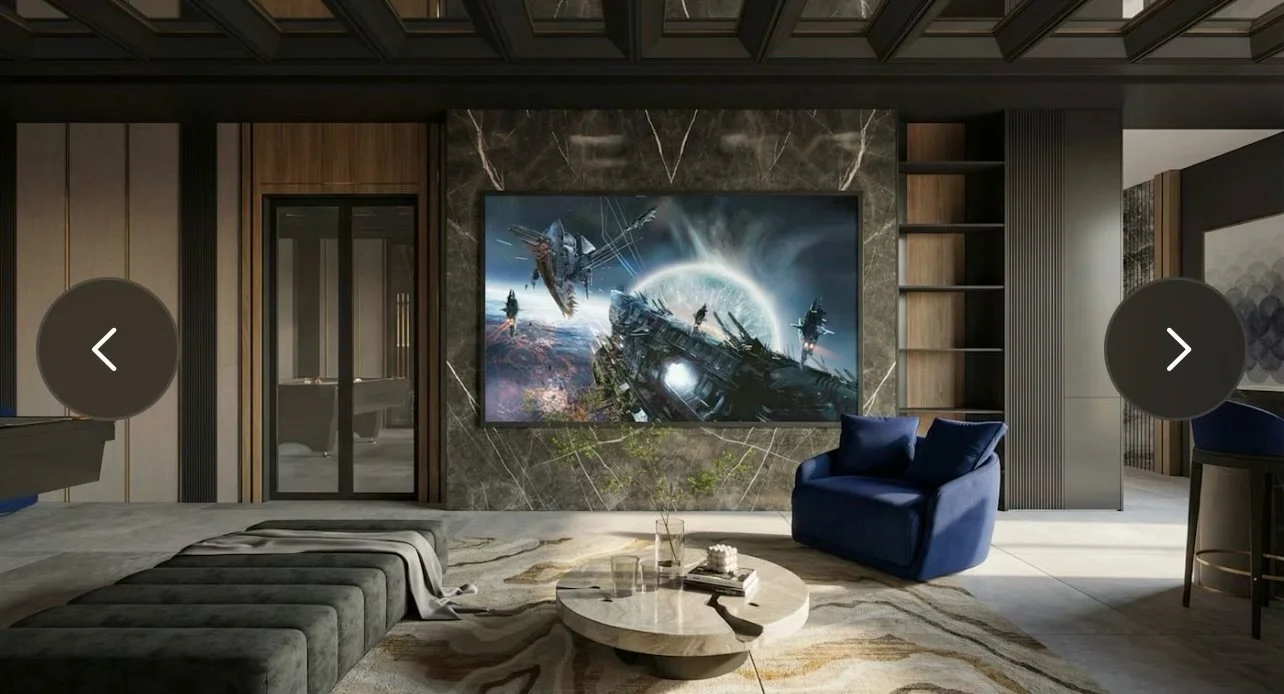 Modern living room with a large wall-mounted screen displaying a sci-fi spaceship scene, a blue armchair, a marble round coffee table, and a patterned rug.