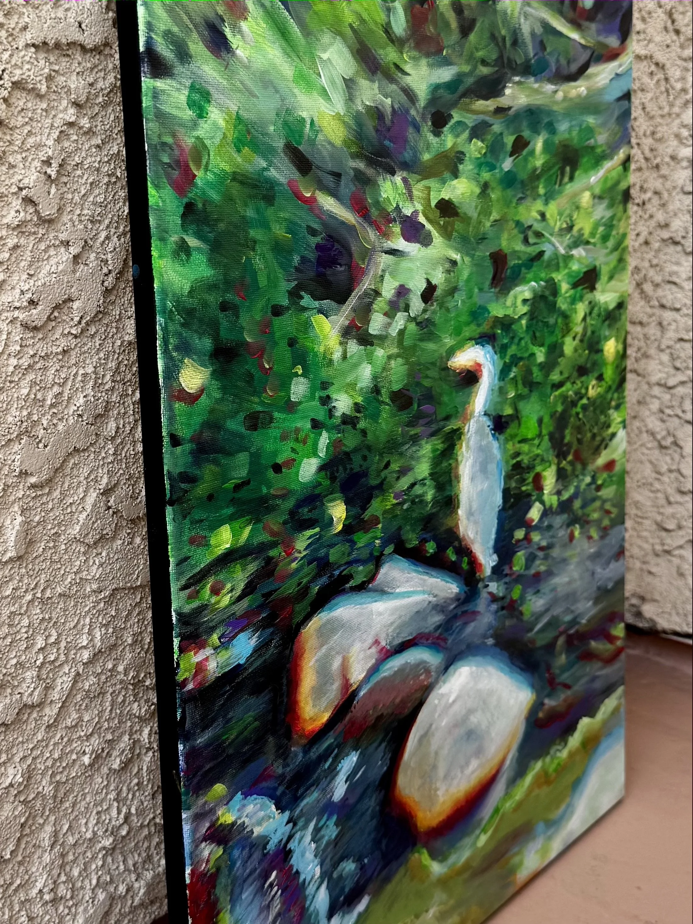 A colorful abstract impressionist painting on a canvas depicting a nature scene with green foliage, and a heron.