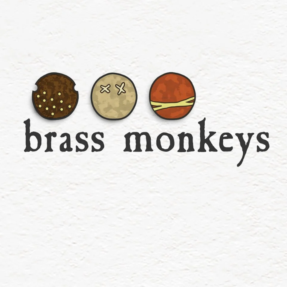 Illustration of three cookie-like objects and text reading 'brass monkeys.'