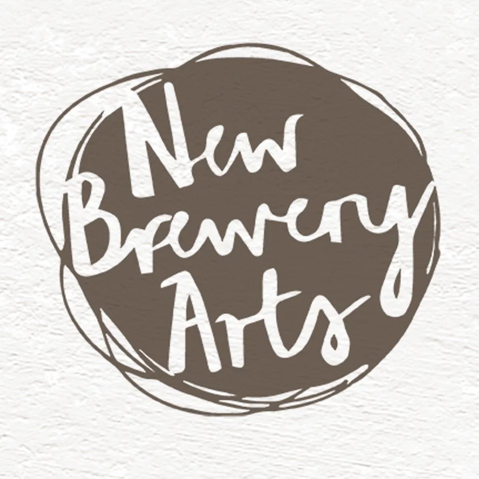 A logo with the text 'New Brunswick Arts' inside a circular, hand-drawn style border.