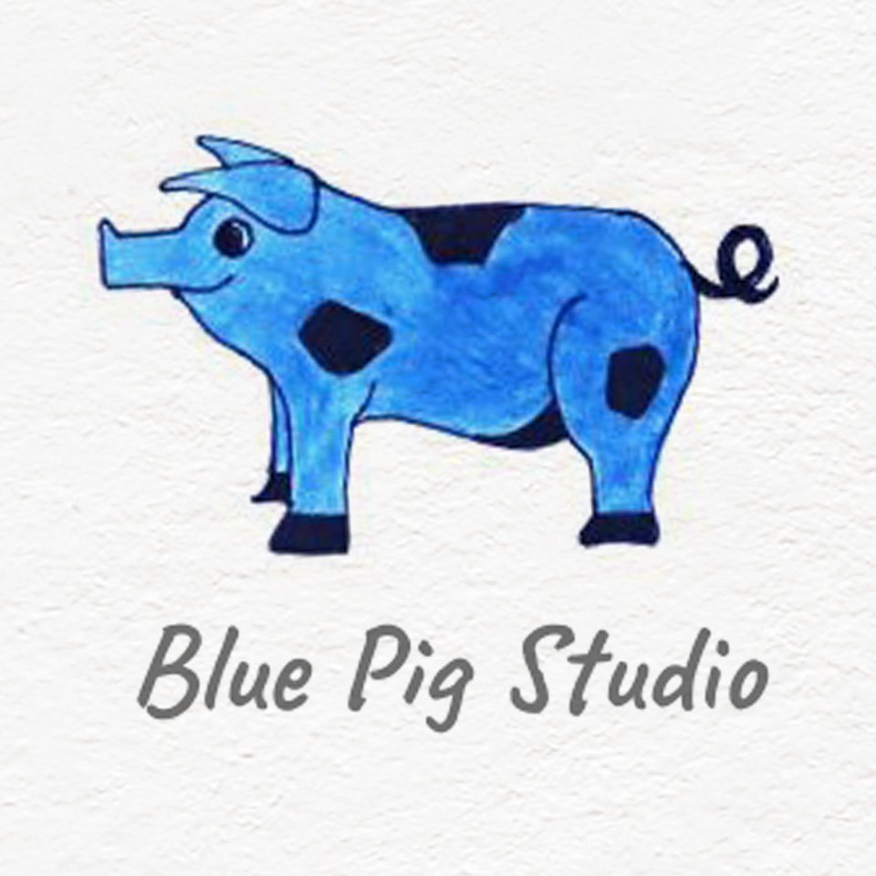 Hand-drawn blue pig with black spots and the text 'Blue Pig Studio' underneath.