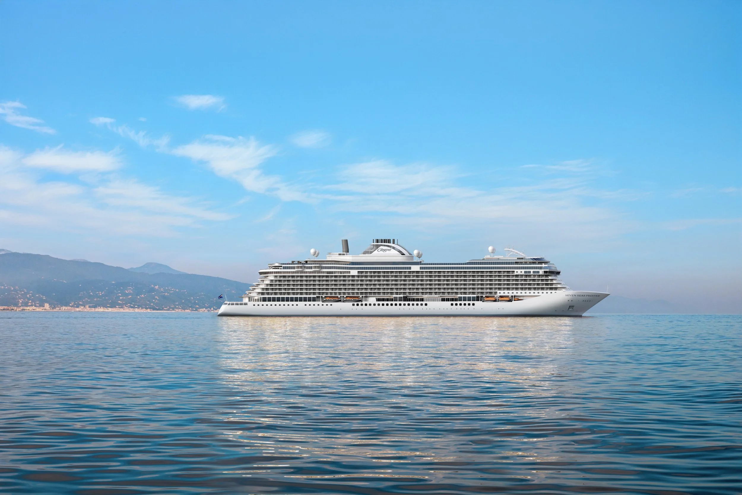 Large white cruise ship sailing on calm water with distant mountainous coastline and partly cloudy blue sky.