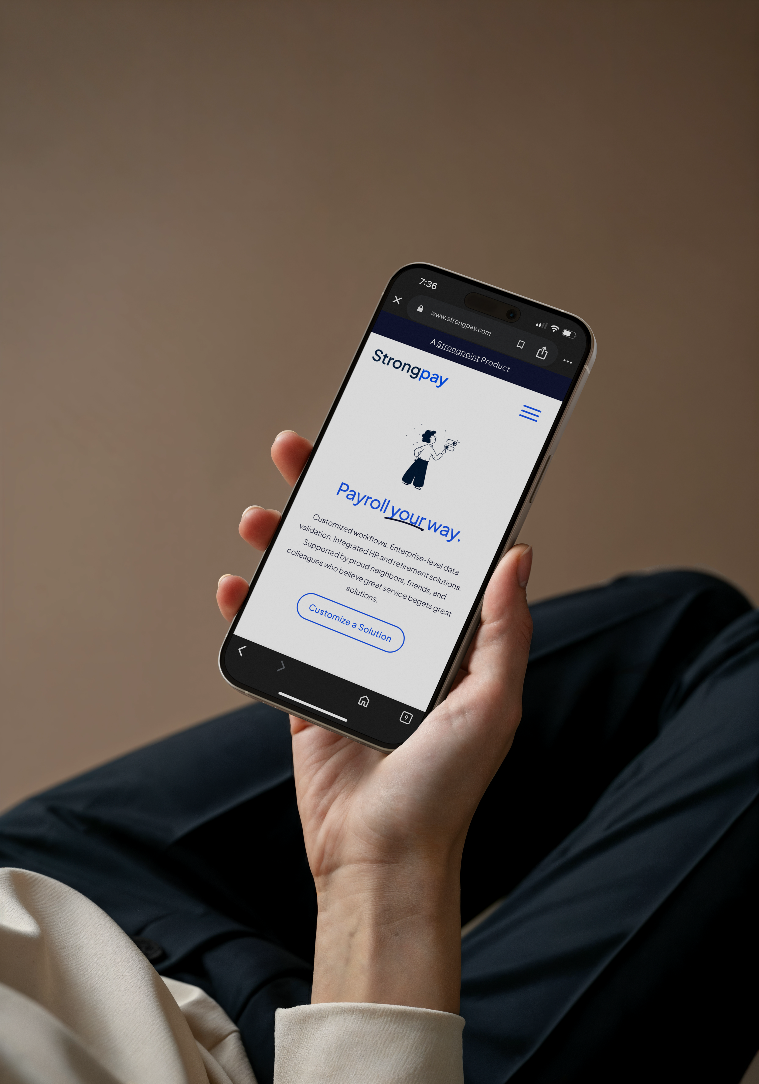 Person holding a smartphone displaying the Strongpay website with payroll services.