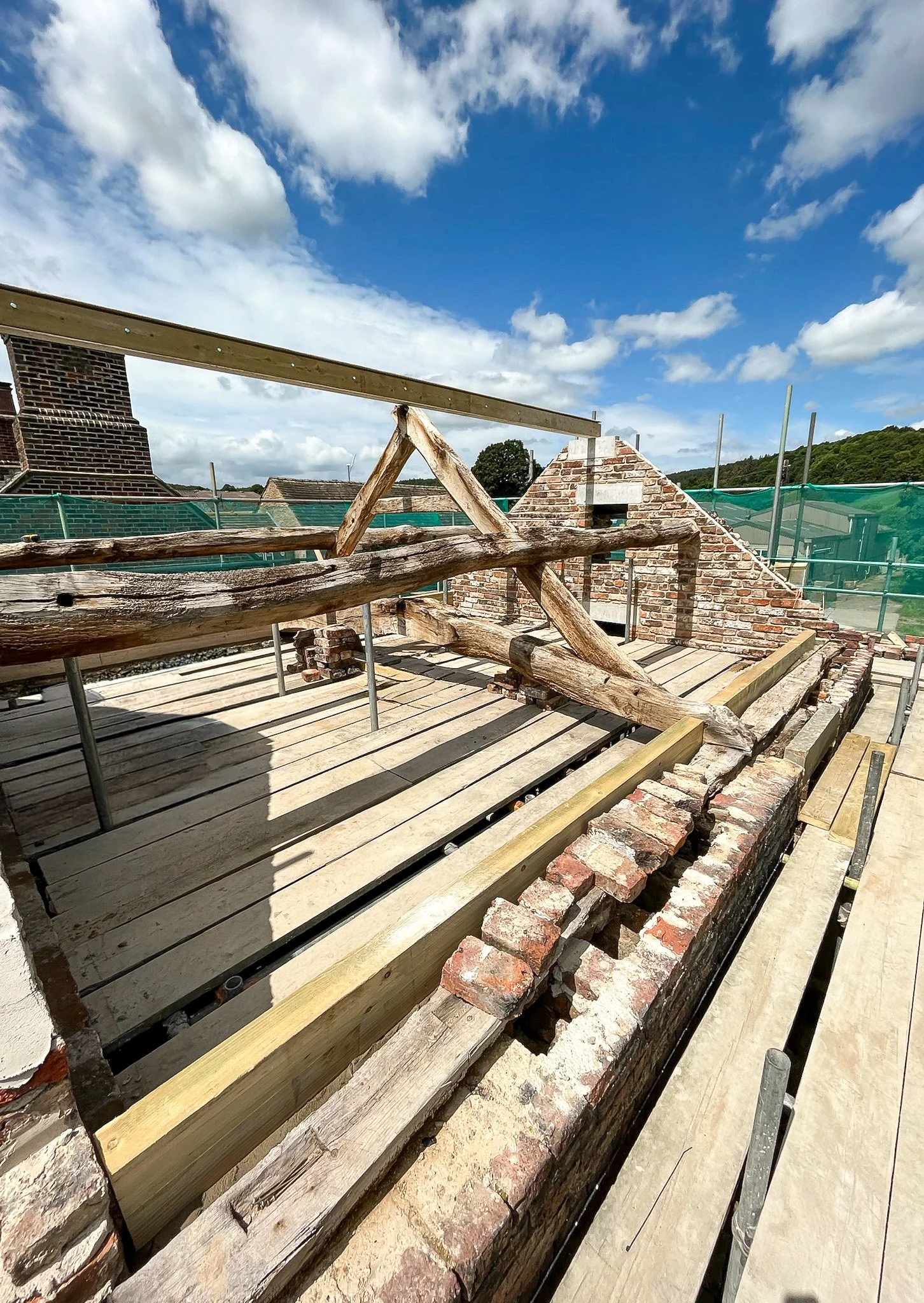 Timber roof reconstruction during the restoration of a traditional stone barn.