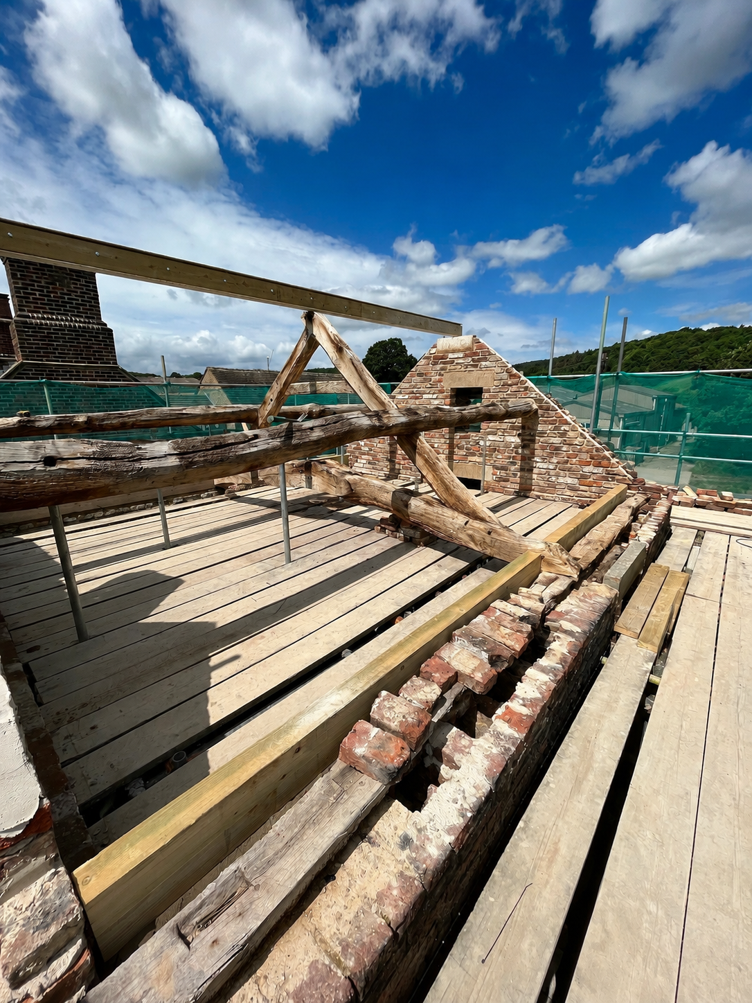 Heritage roof restoration showing original timber trusses, brickwork and traditional construction.