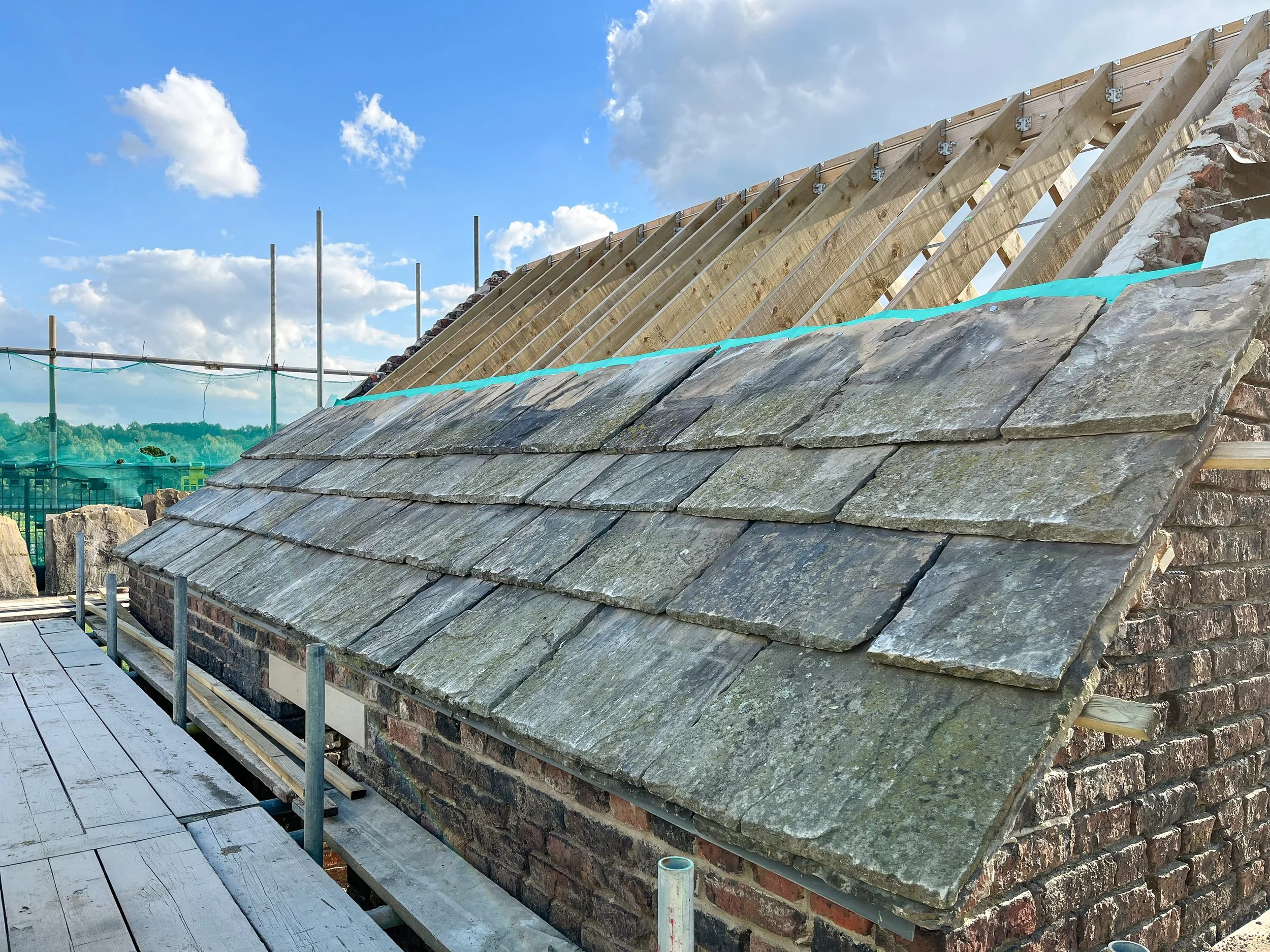Traditional slate roof restoration carried out during the barn conversion project.
