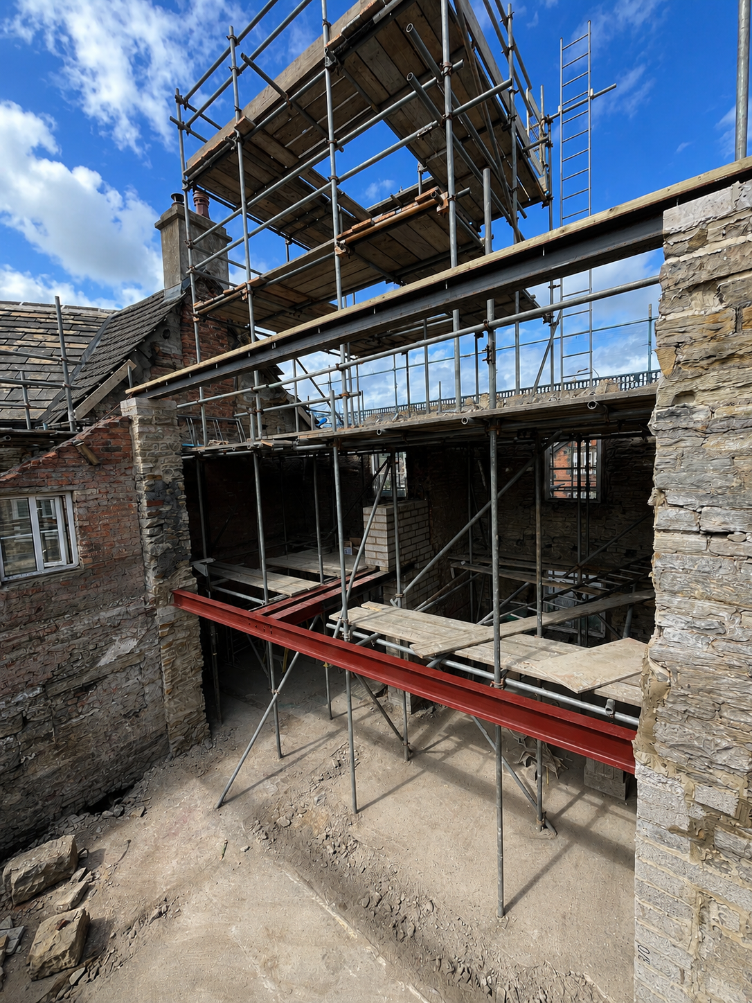 Structural alterations and scaffolding during the conversion of the property into apartments.