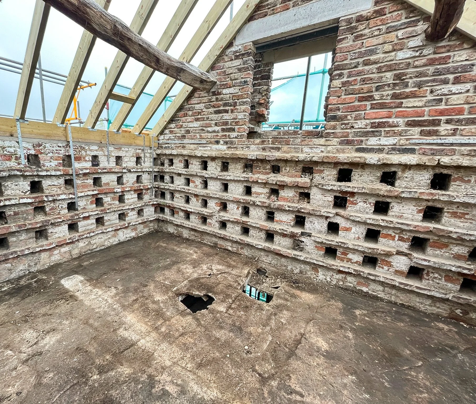 Internal structural alterations showing retained masonry and new roof structure.