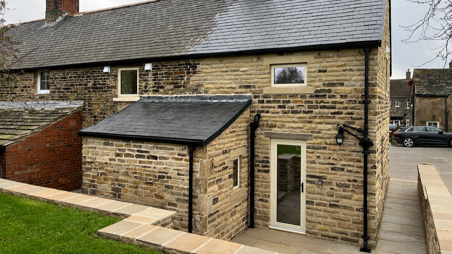 Traditional stone house extension constructed to match the existing property.