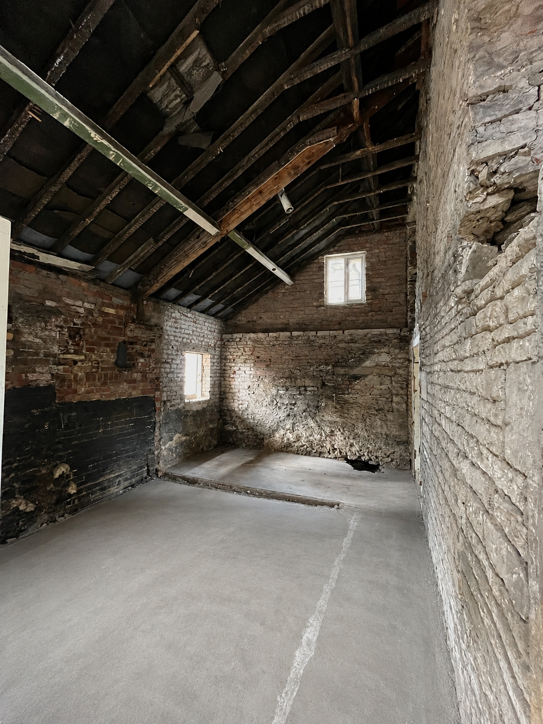 Internal strip-out exposing the original structure before renovation works.