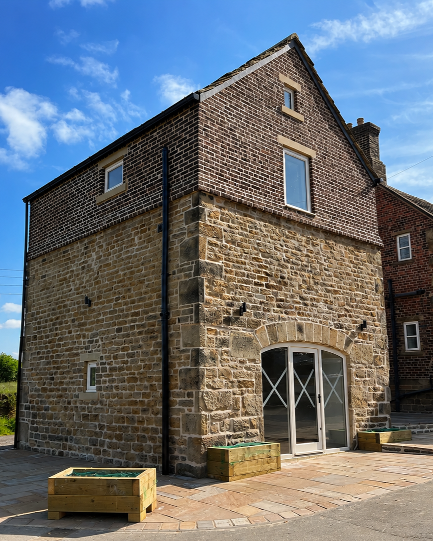 Historic stone barn converted into modern office space with restored stonework and traditional character.