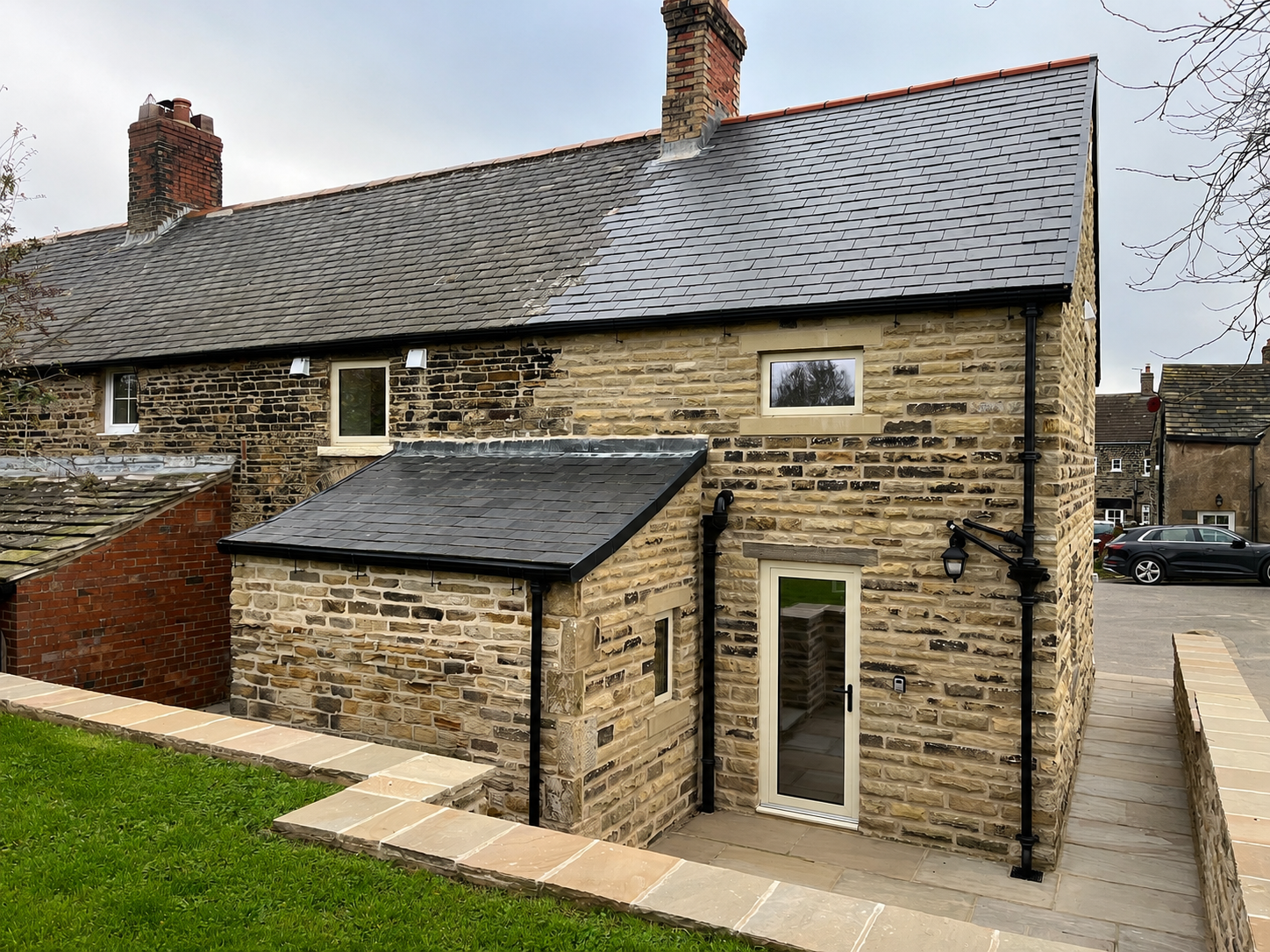 Finished rear view of the completed double storey side extension with matching stonework.