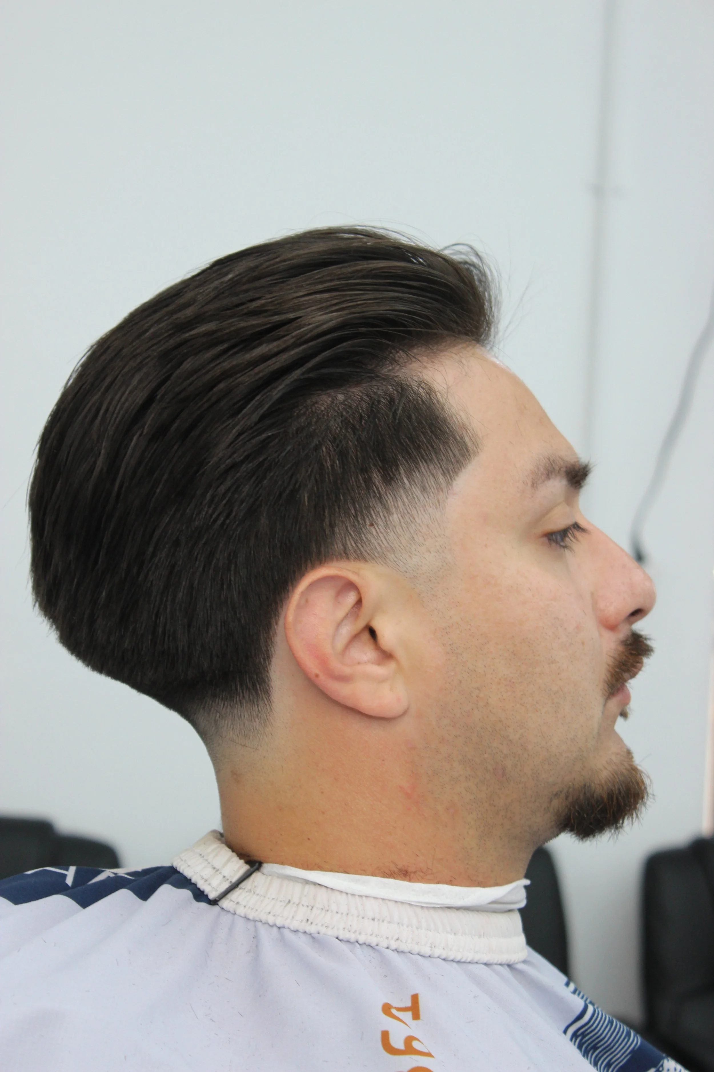 arber giving a skin fade at Precision Barbershop in Oxnard, California.
