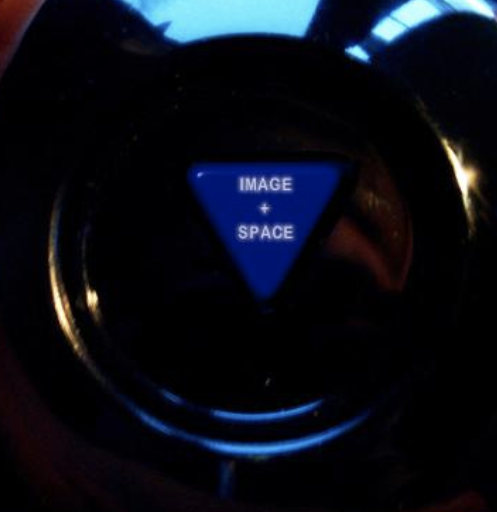 Car dashboard control button labeled 'Image + Space' in blue with a black background.