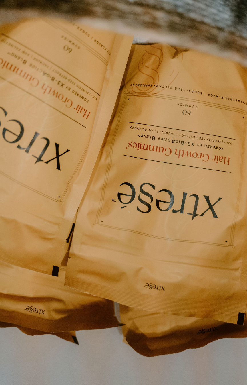 Close-up of multiple beige powdered tea packets with the label "XiuSe" and text indicating they are "Half Crown Creams"