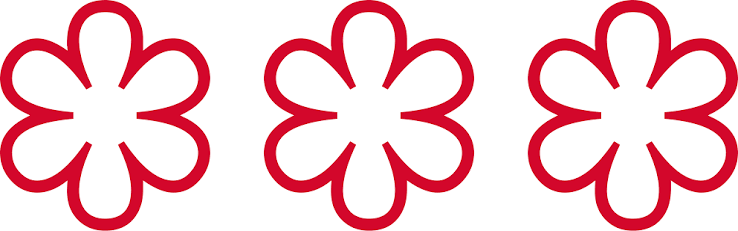 Three Michelin Stars emblem representing Alinea during Chef Mike Bagale's tenure as Executive Chef.