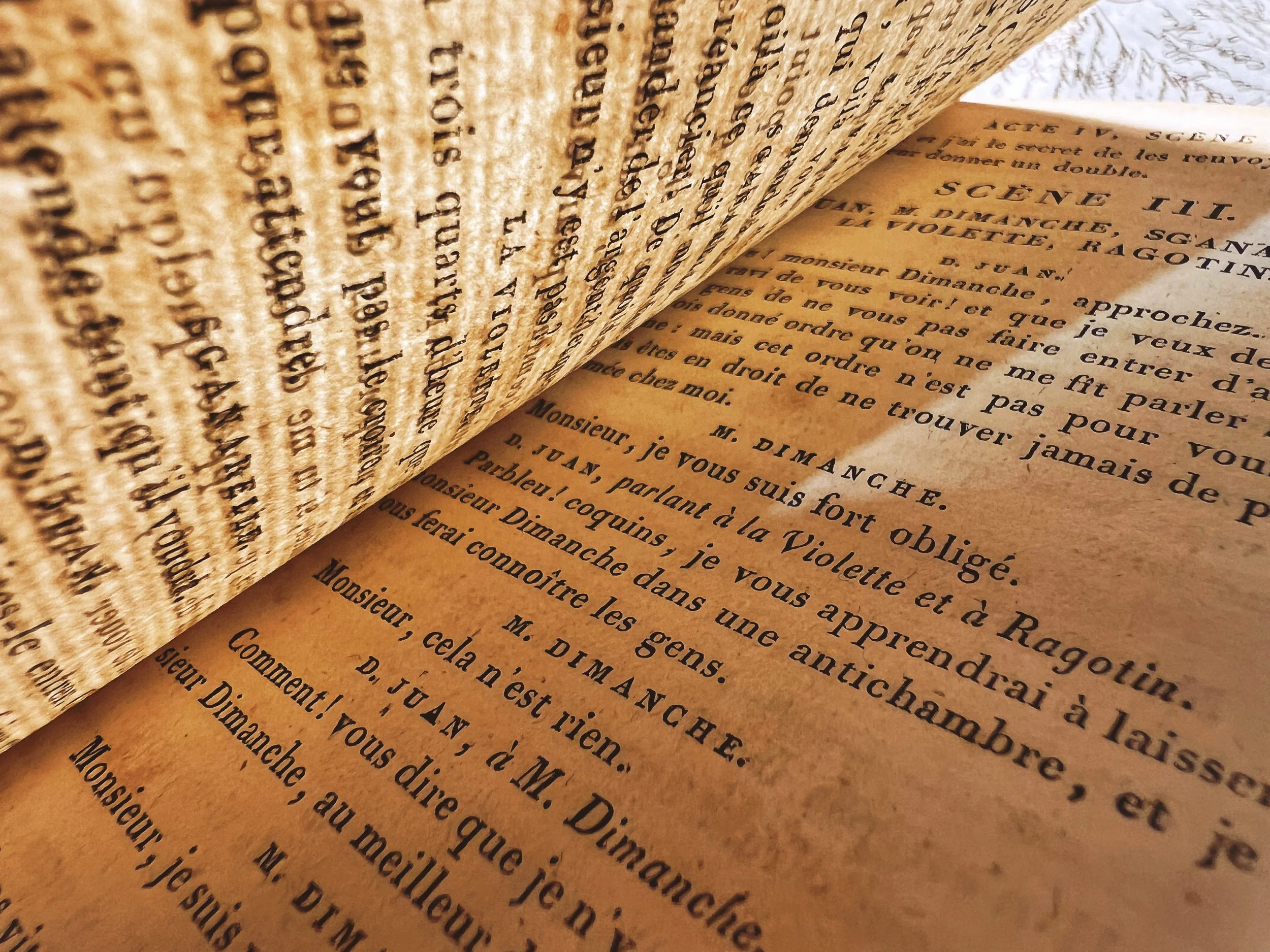 Close-up of aged printed pages, representing Cassie Xue’s academic writing, research, and critical work in theatre and performance studies.