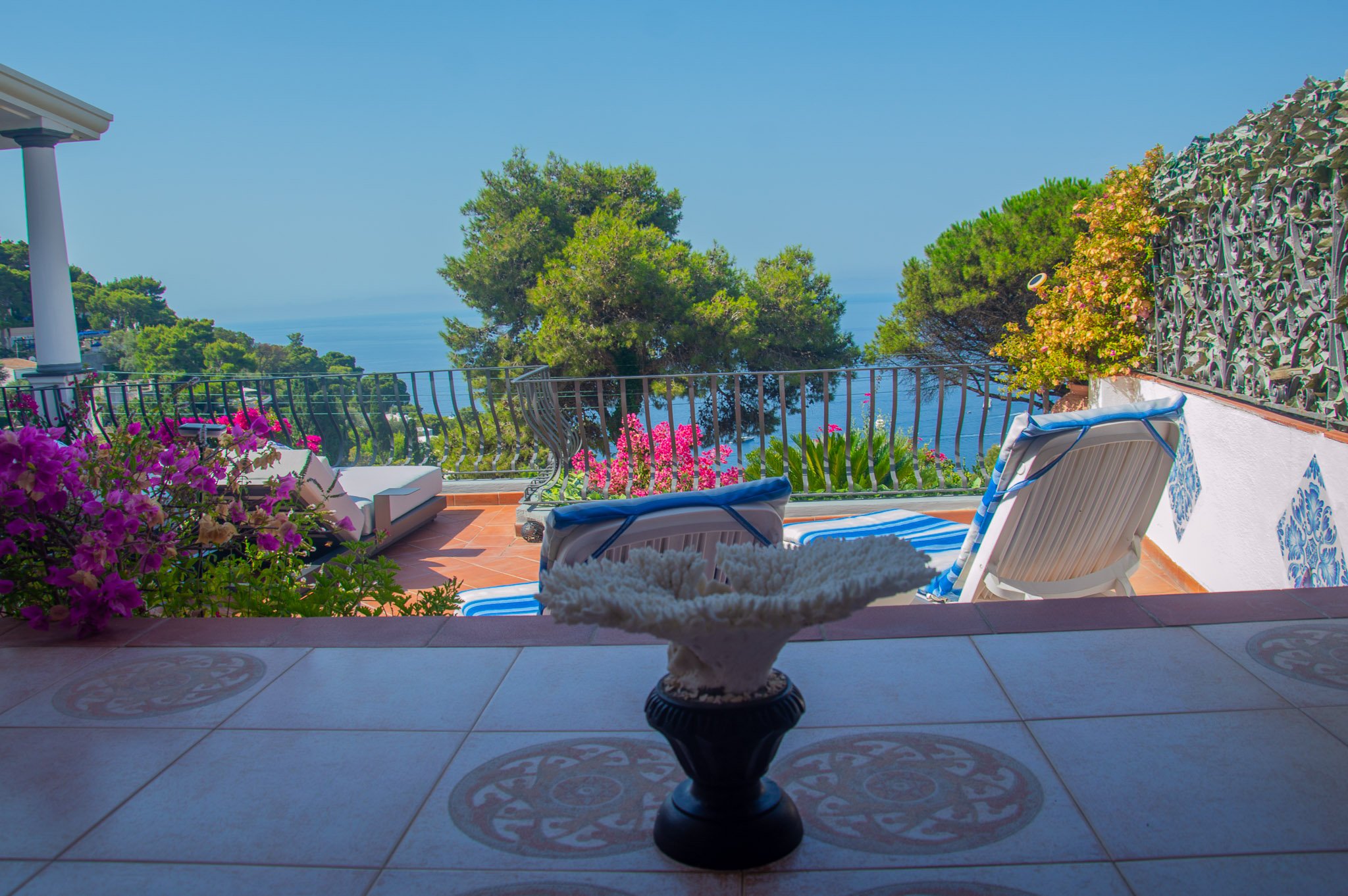 Decorative white coral accent piece on an outdoor table overlooking the deep blue sea.