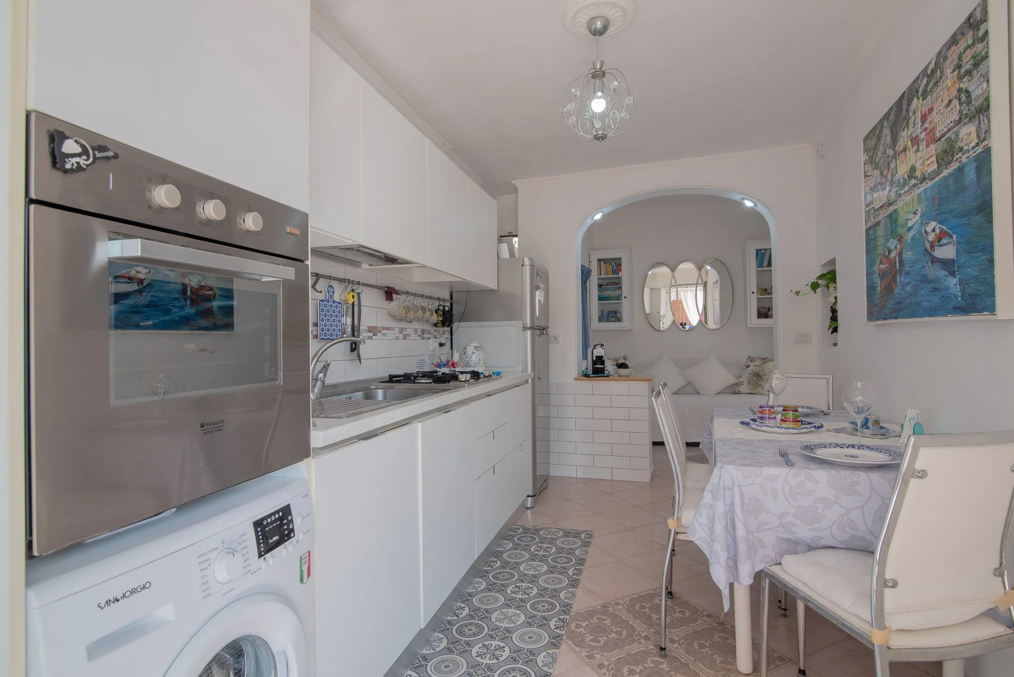 Fully equipped modern white kitchen and dining area at Marvelous Capri stay.