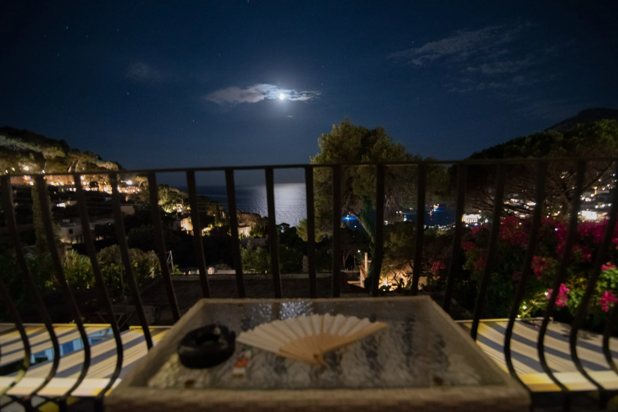 Moonlight reflecting on the sea from the private balcony of a Capri trip retreat.