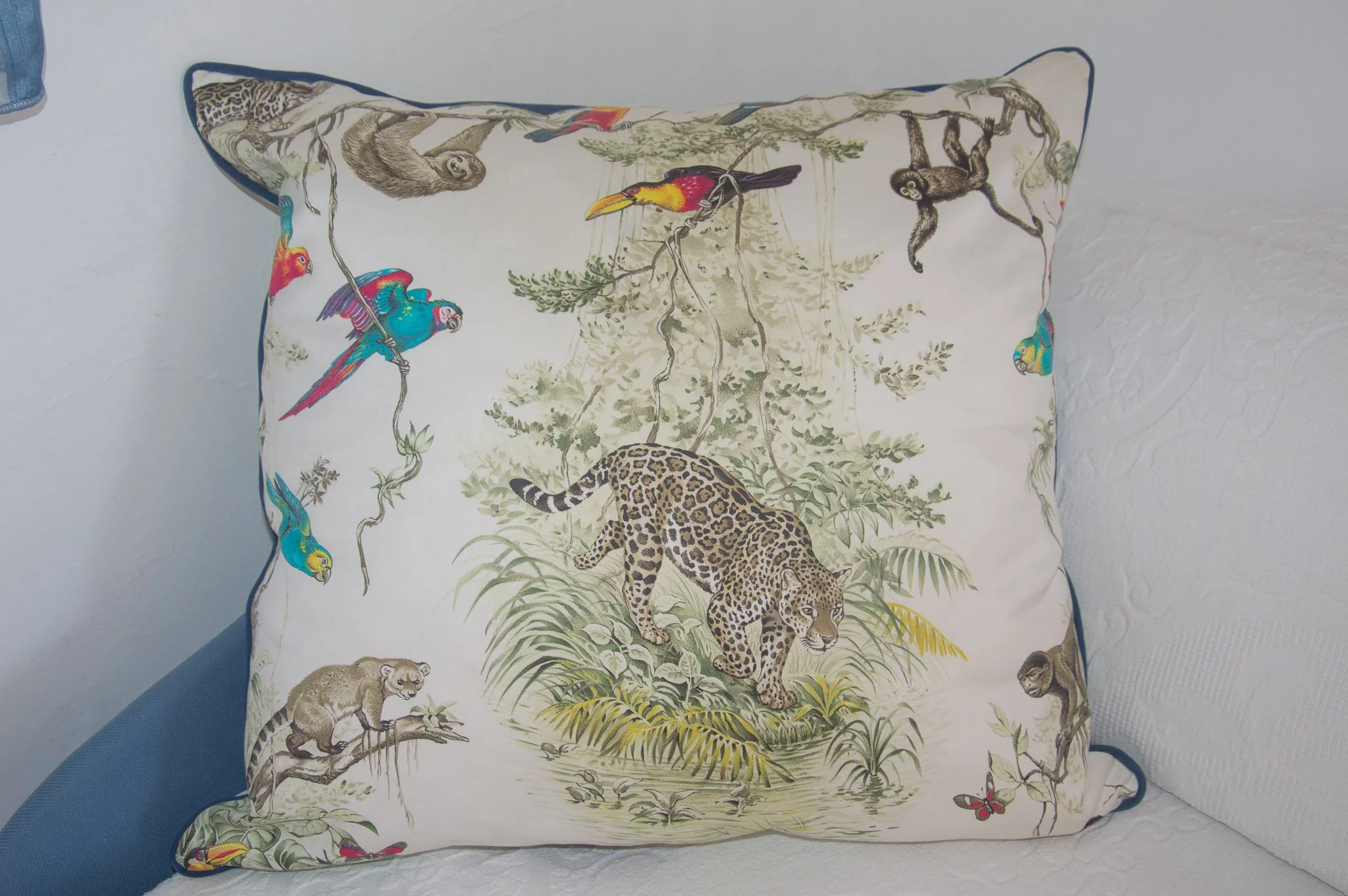 interior details featuring an upscale Versace tropical print silk pillow.