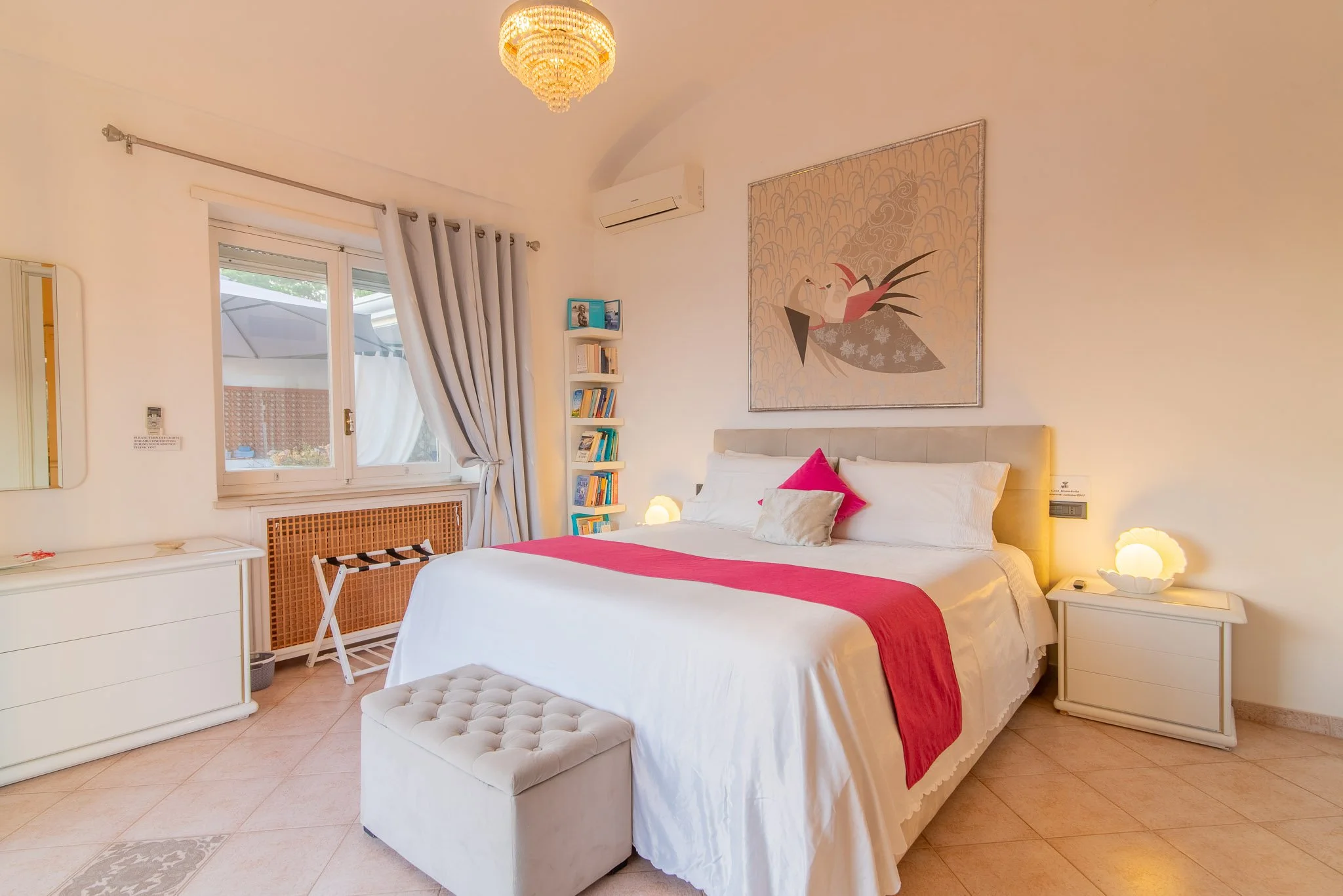 Elegant master bedroom at Marvelous Capri vacation rental illuminated by warm sunset light.