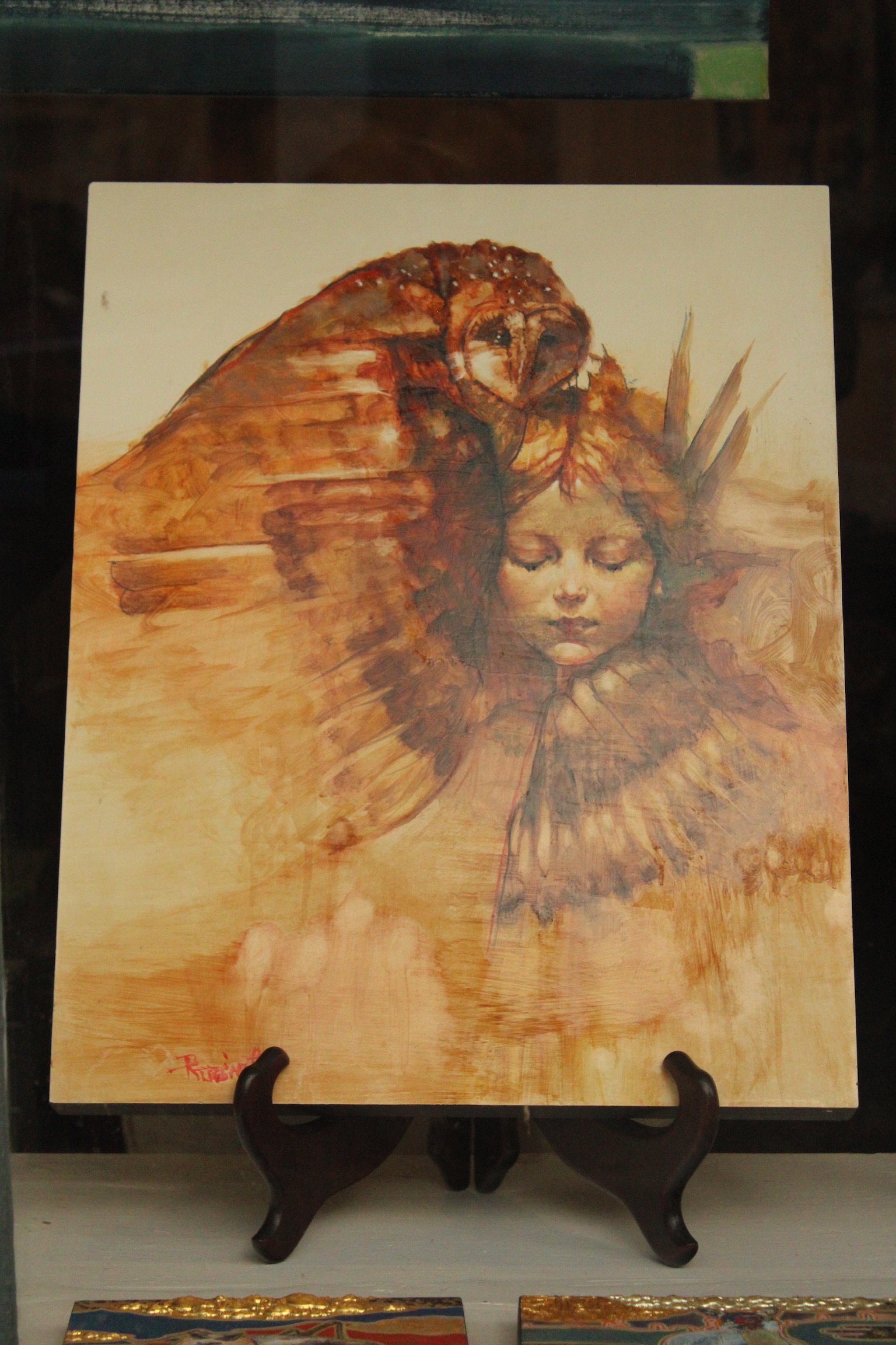A painting of an owl perched on a person's head, with the person's eyes closed, surrounded by a warm, earthy color palette.