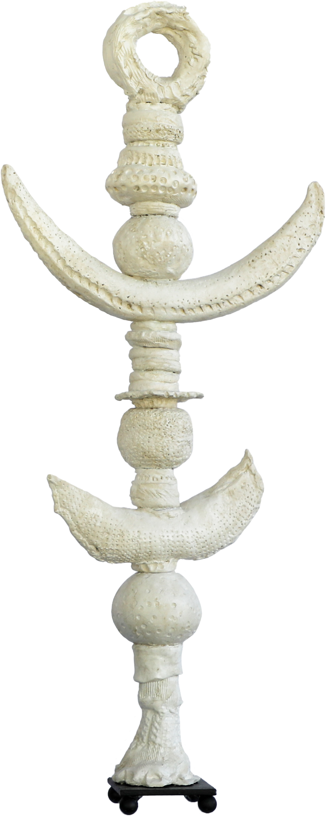A sculpture made of seashells arranged vertically on a black base.