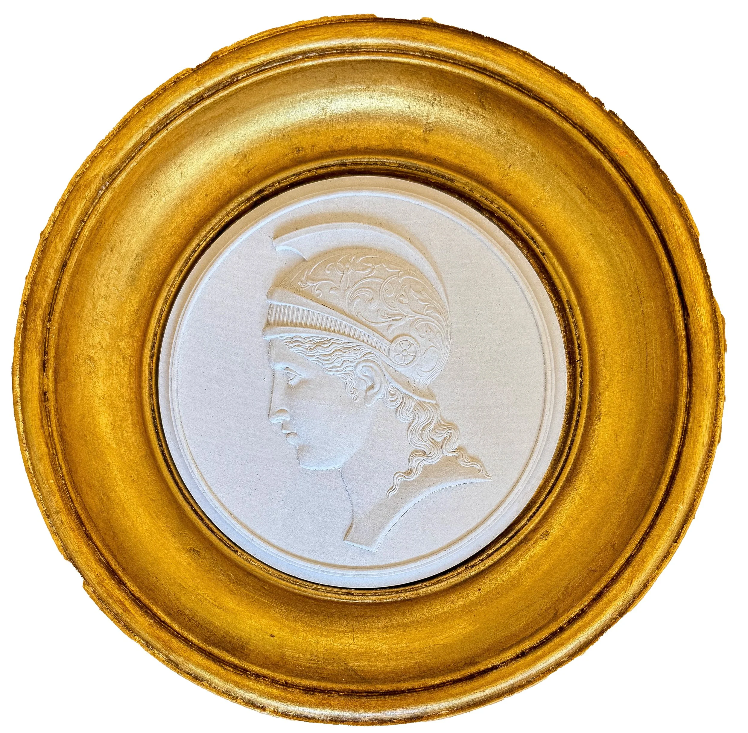 Close-up of a decorative, gilded frame surrounding a carved, white cameo-style profile of a woman with flowing hair.