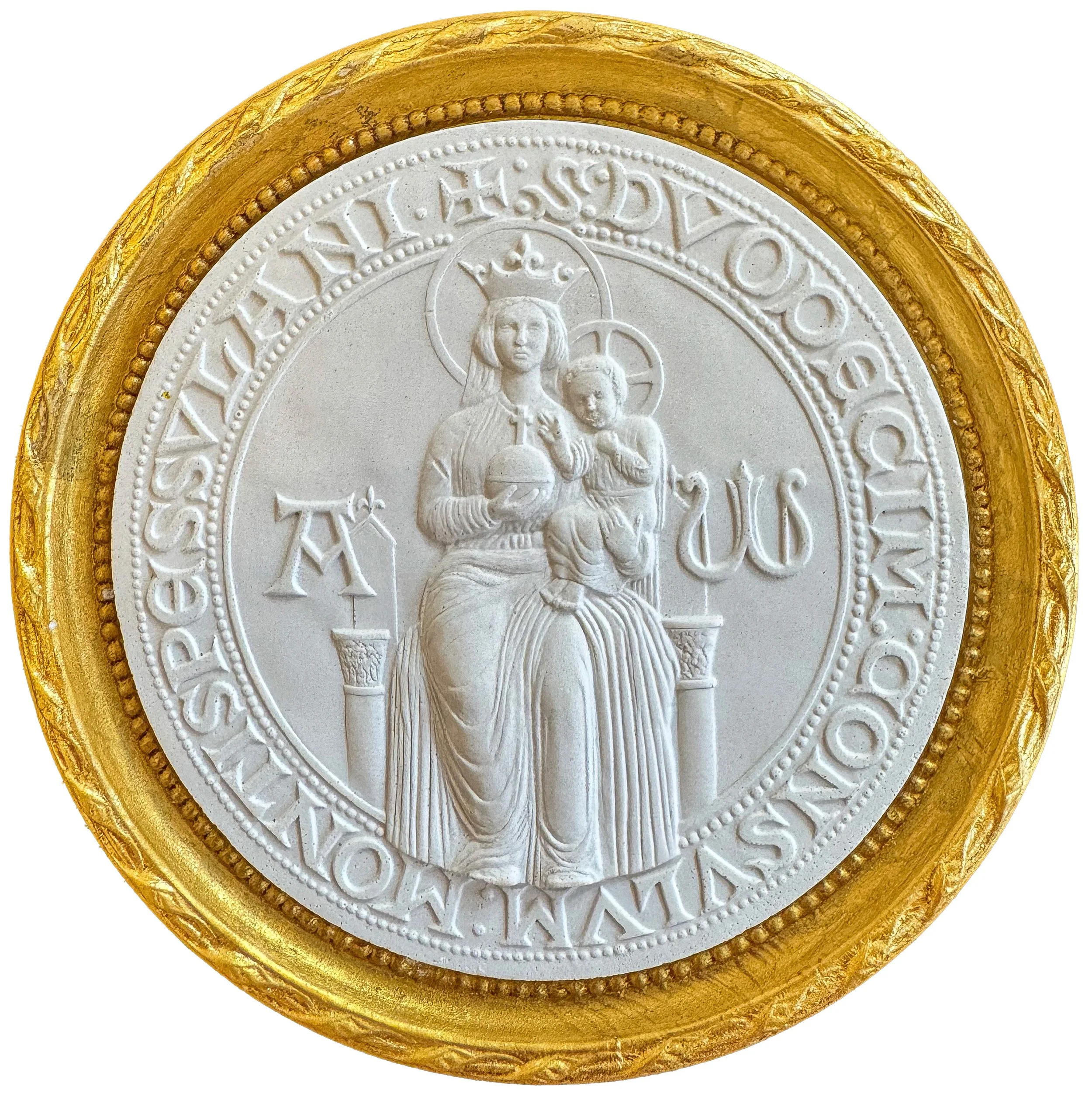 Close-up of a commemorative coin with a gold rim and a white center featuring a religious image and text.