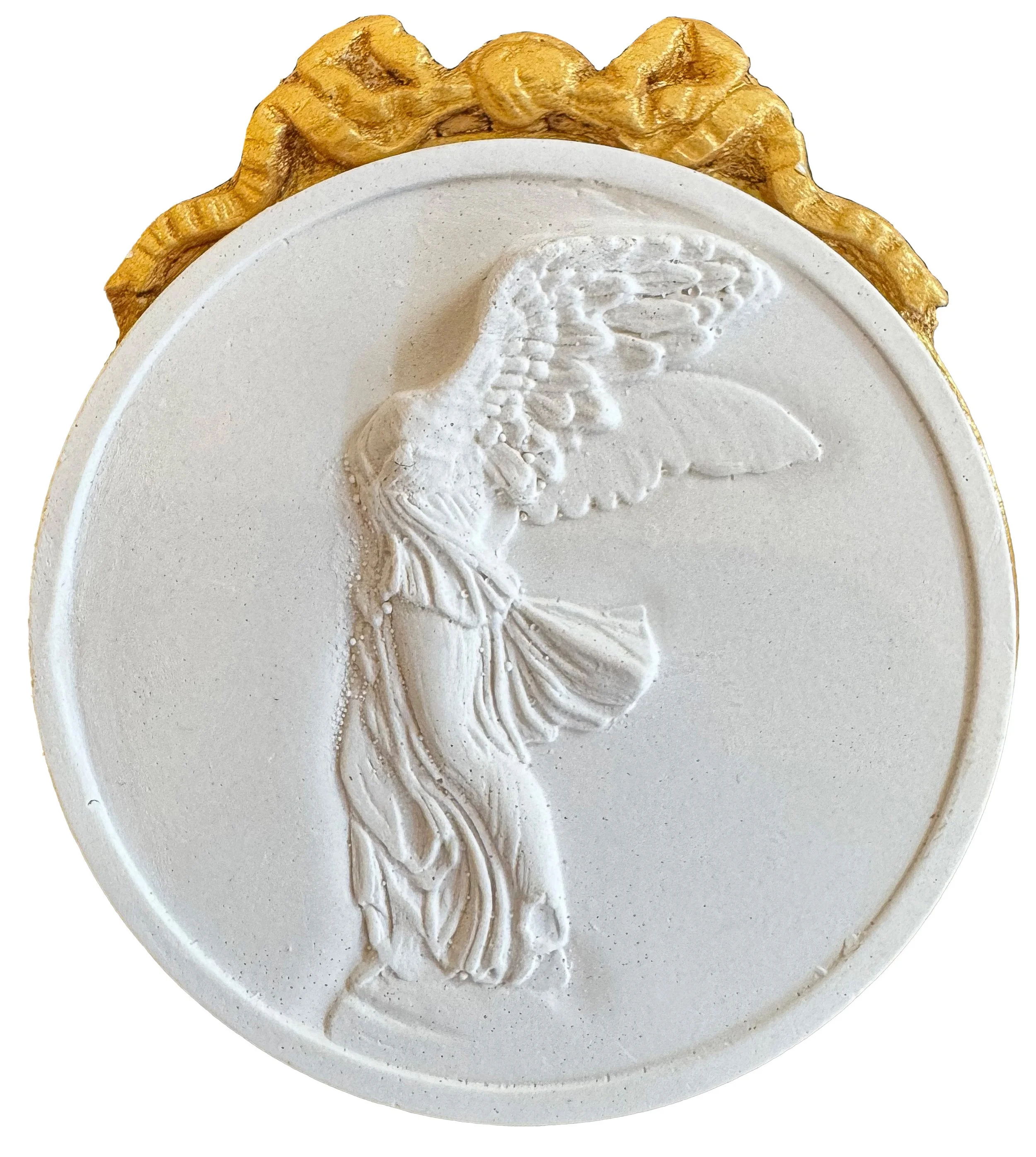 White oval ceramic plaque with a carved flamingo and decorative border, with partial gold embellishment on top