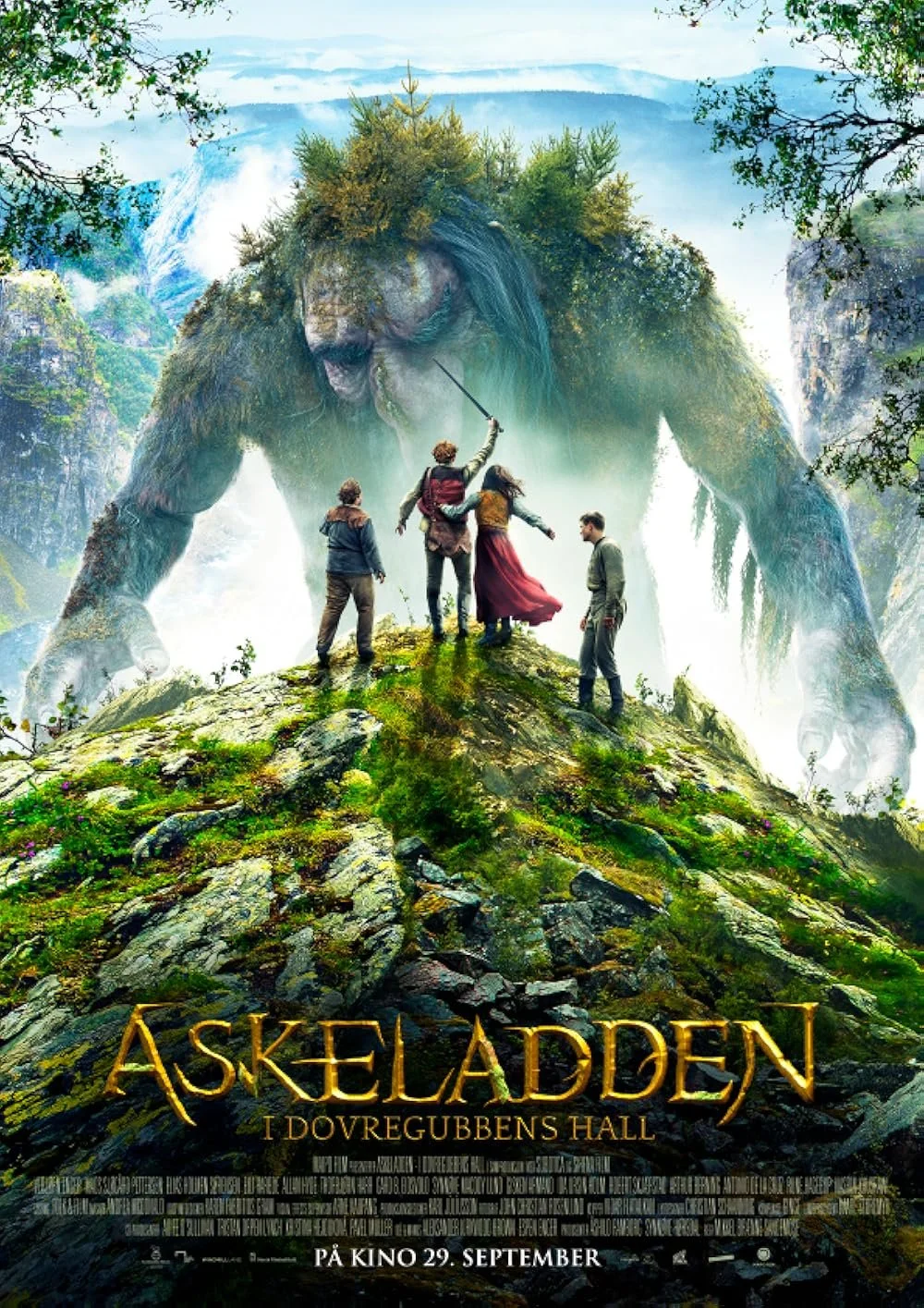 A fantasy movie poster featuring four people facing a giant moss-covered creature resembling a troll or giant. The creature stands in a lush, misty forest with mountains in the background. The title reads 'Askeladden i Dovregubbens Hall,' indicating a Norwegian fantasy film, with a release date of September 29.