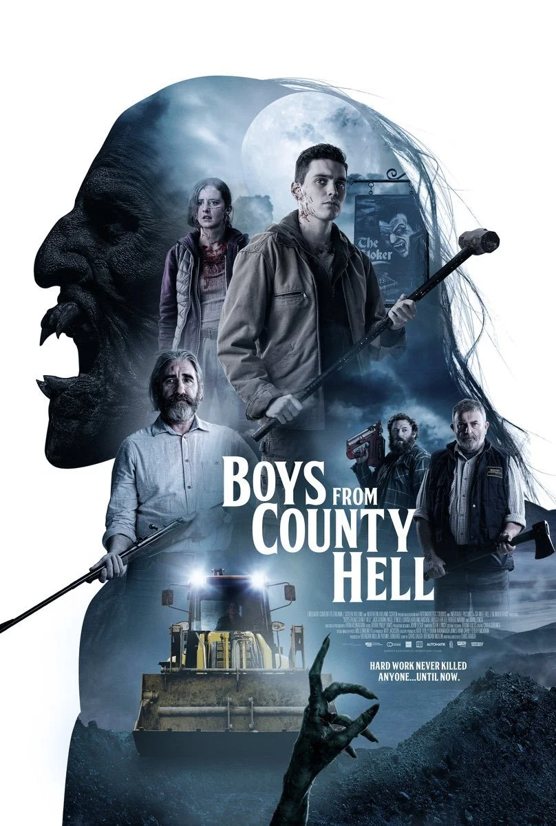 The poster for the movie "Boys from County Hell" features a dark, moody background with a large monstrous face silhouette on the left. Inside the silhouette, a scene with full moon and cloudy sky is visible. The central figures are a young man holding a sledgehammer, and three other characters, one holding a tool, two with weapons, and one with a drill. A large construction vehicle is at the bottom, with a zombie-like hand reaching up from the ground. The film's title and tagline read, "Hard work never killed anyone... until now."