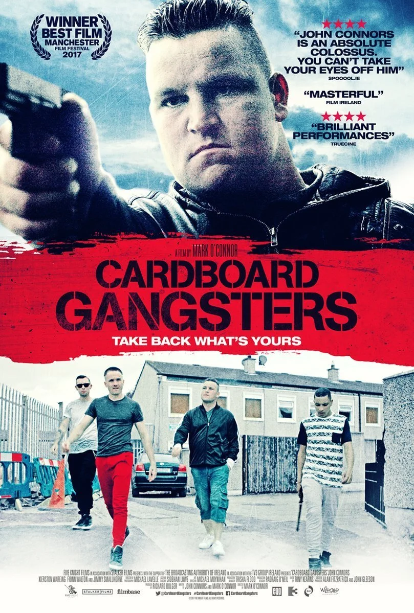 Movie poster for Cardboard Gangsters featuring a man pointing a gun with a group of young men walking in an alleyway, with quotes and awards on the poster.