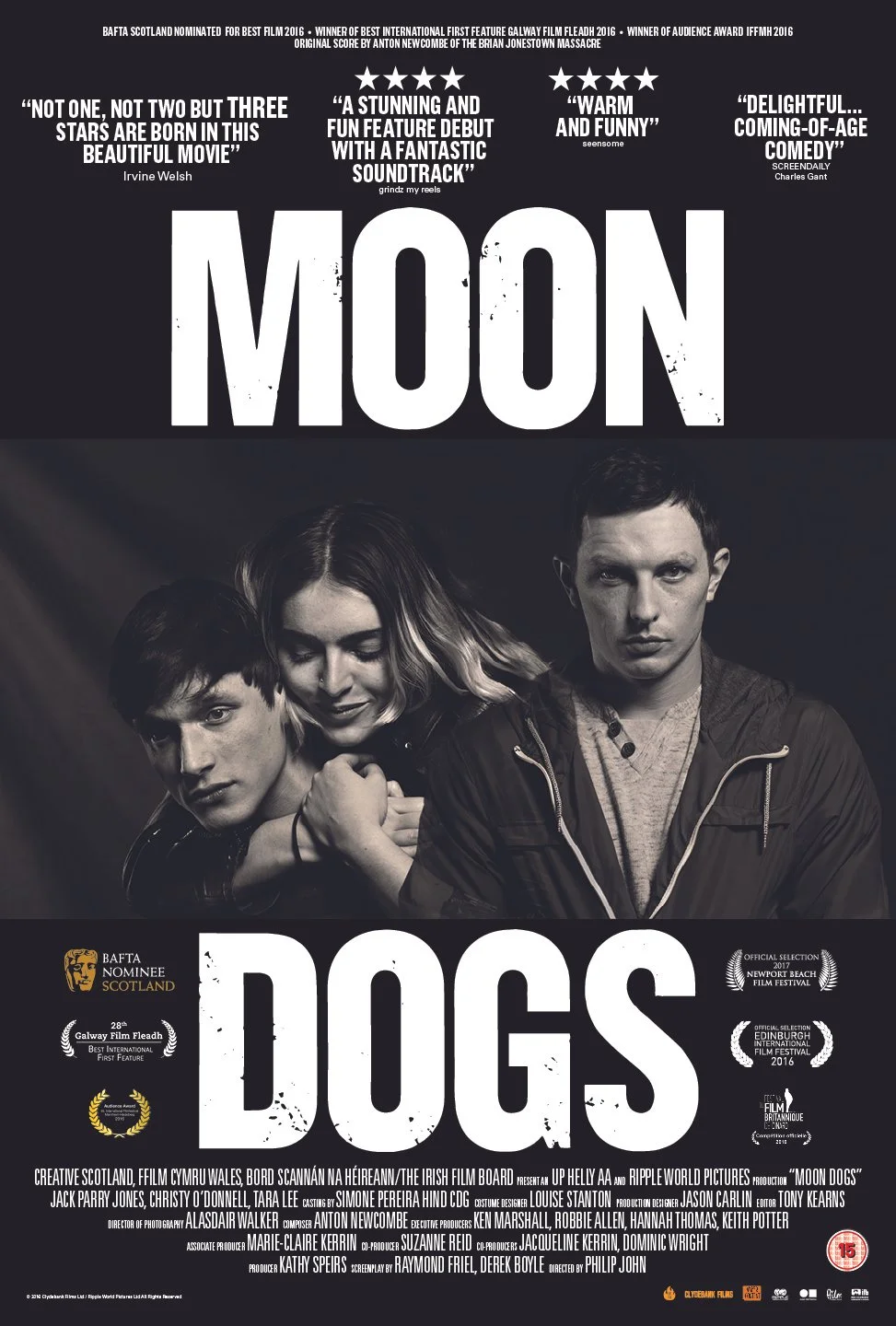 Movie poster for 'Moon Dogs' featuring three young cast members in black and white photo. The title 'Moon Dogs' is prominently displayed in large white letters at the top and bottom. Quotes and reviews about the film are at the top, with awards and festival selections at the bottom. Credits for cast, crew, and production companies are listed at the bottom of the poster.