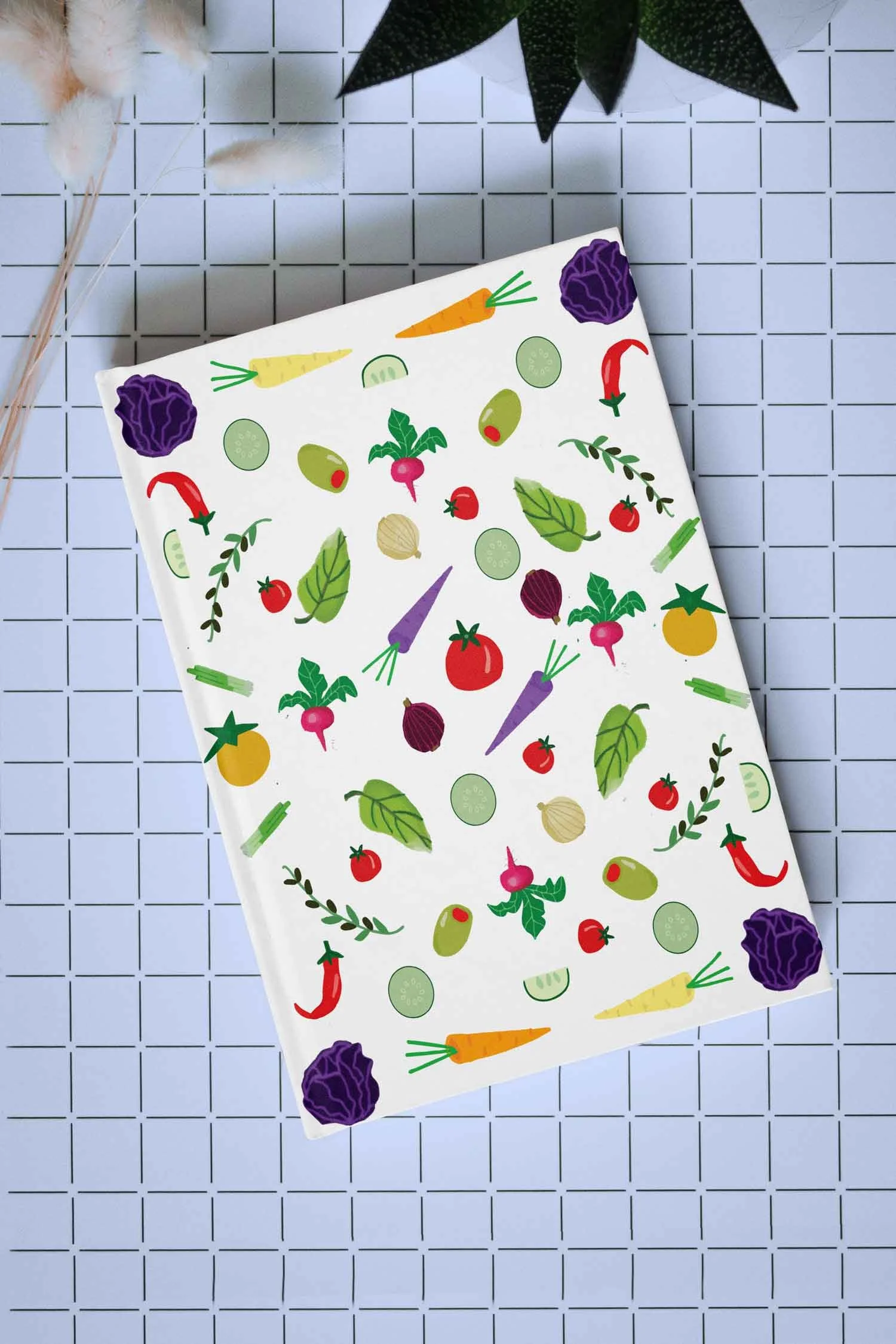 A journal with artwork by Studio Victoria Louise of deconstructed salad elements.