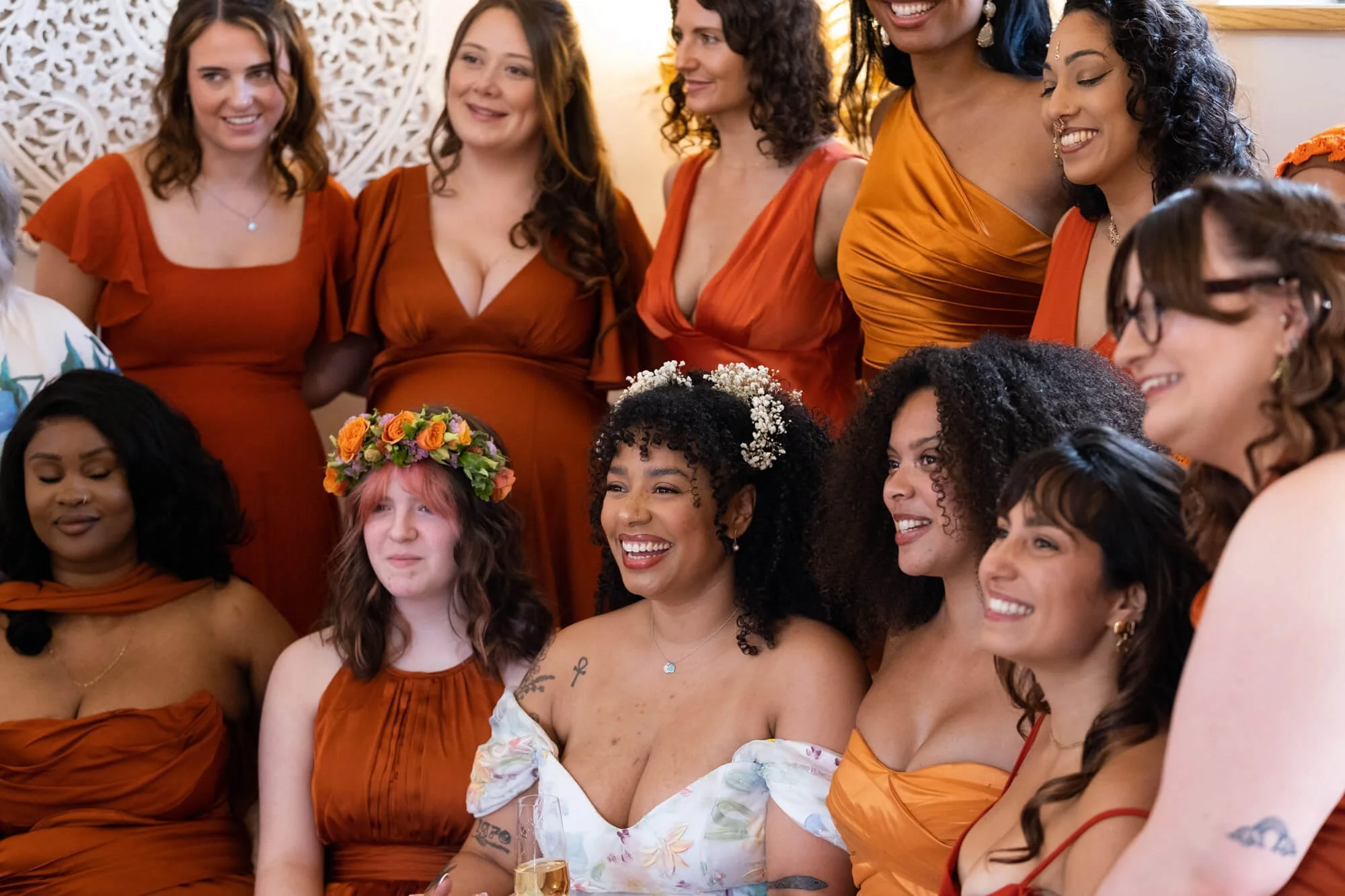 A bride and her bridesmaids pose before the ceremony after getting ready.