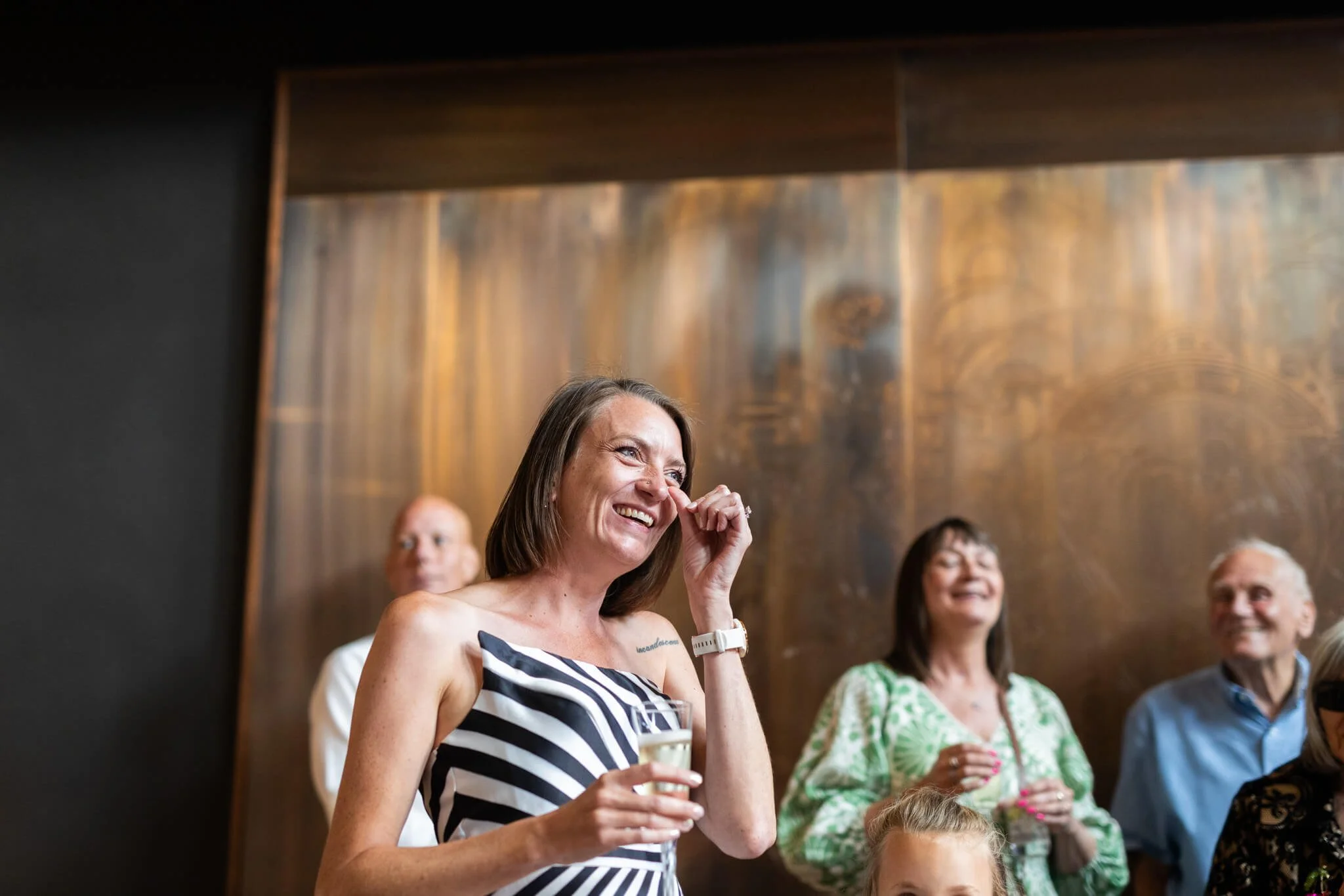 A bride listens to her fathers speech at the bombay sapphire distillery