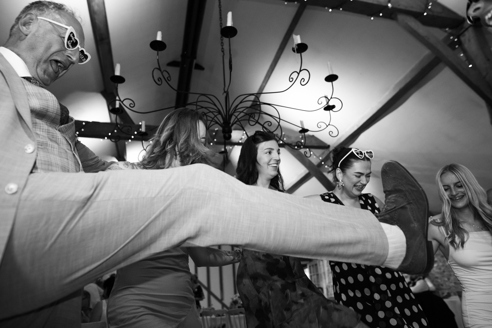 Guests dancing in the main hall at upwaltham barns